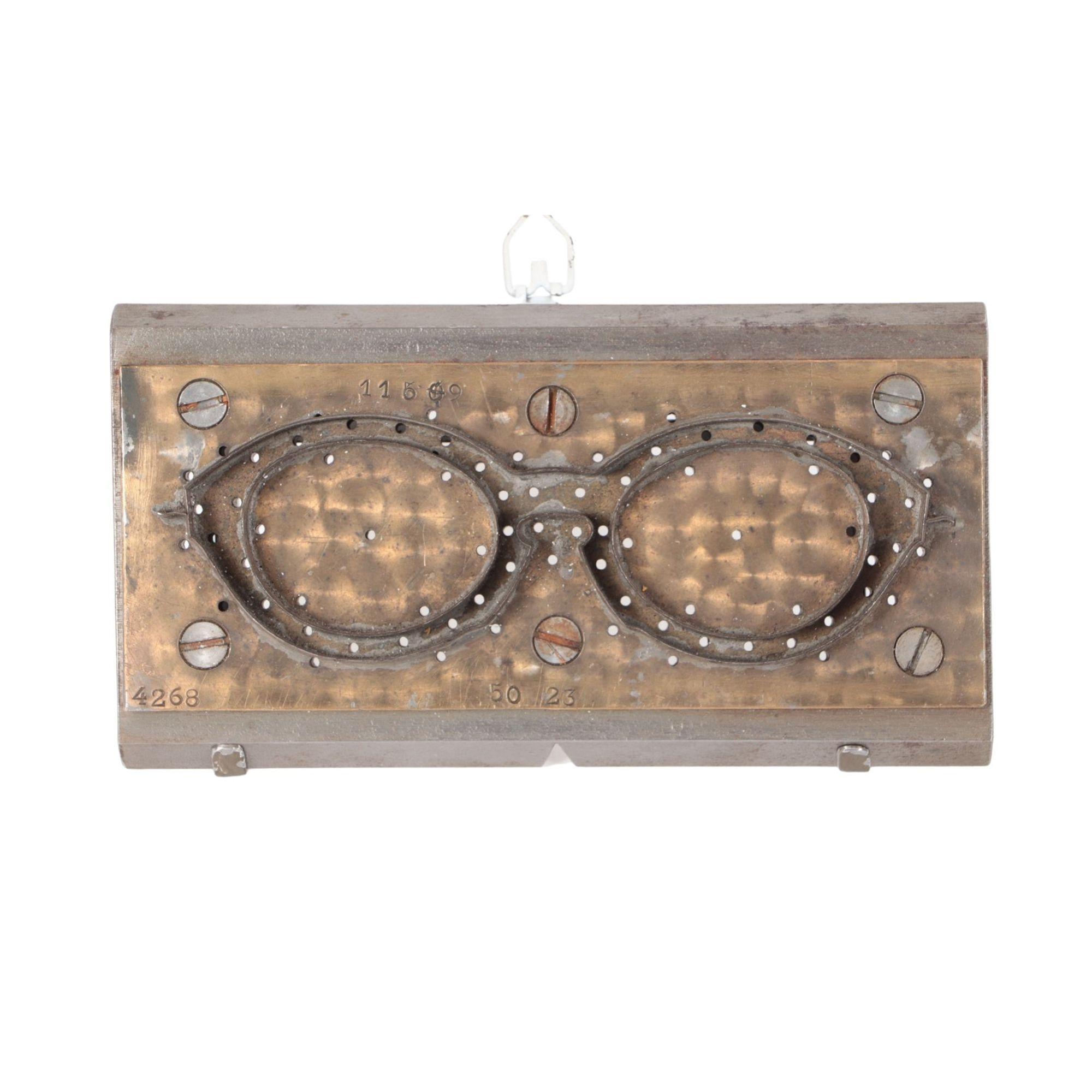 A Vintage midcentury steel and brass eyeglass sculpture circa 1950.The mold is screwed to heavy steel forms with front and back beveled edges.