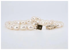 A vintage Mikimoto signed double strand pearl bracelet mounted on 14 karat gold.