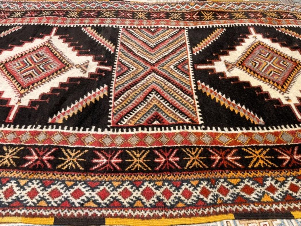 Vintage Berber rug from the Taznakht tribe in southeastern Morocco. Rare piece with beautiful color combination.

The Djoharian Design Collection is located in Germany, all our rugs are shipped from there. We are licensed FAIR-TRADE partner of LABEL