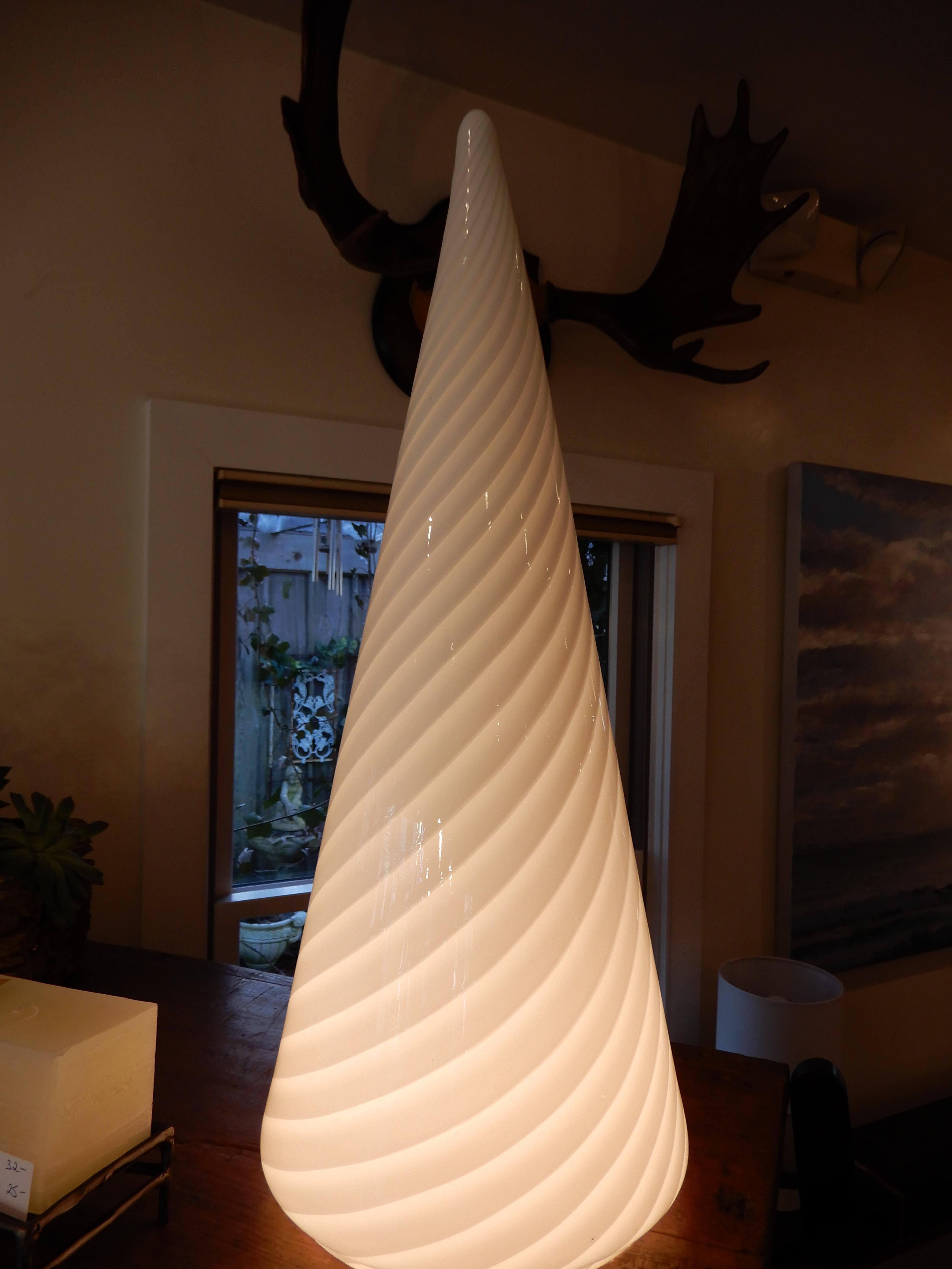 In the classic Vetri style this beautiful cone shaped Murano glass lamp sits well on a table, in the corner on the floor, in the hearth, anywhere, the light gives of a warm glow. Vintage modern 1970s.