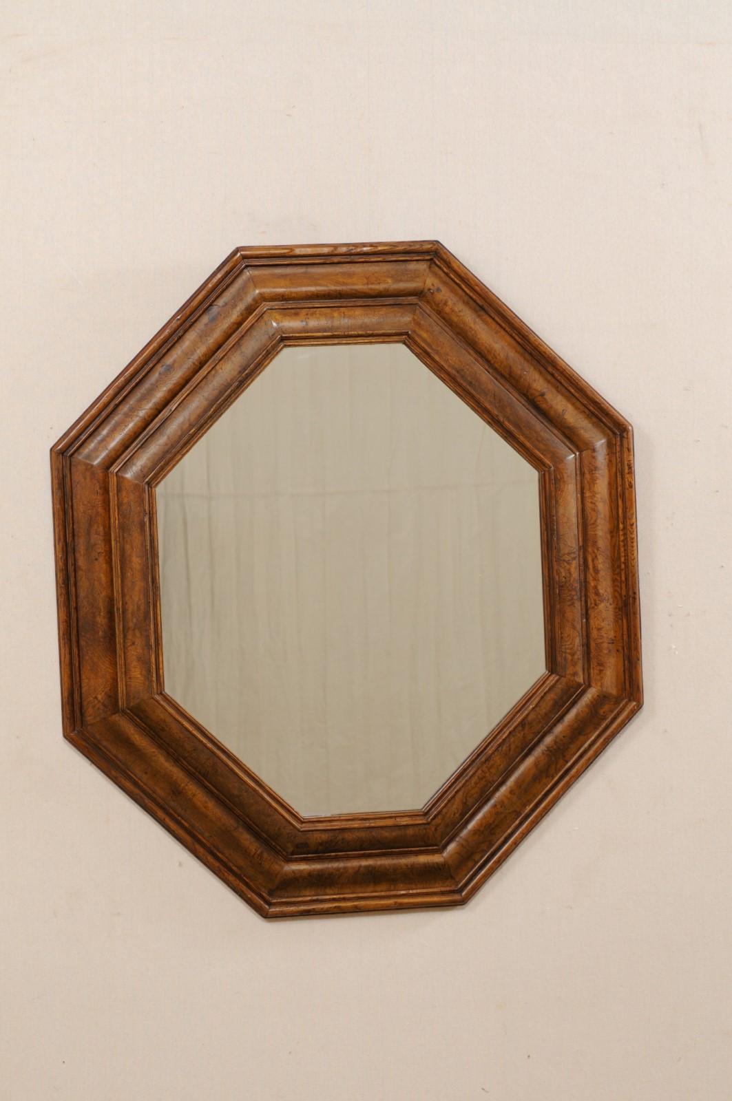 A burled walnut octagon-shaped mirror, 20th century. This vintage mirror from furniture makers 