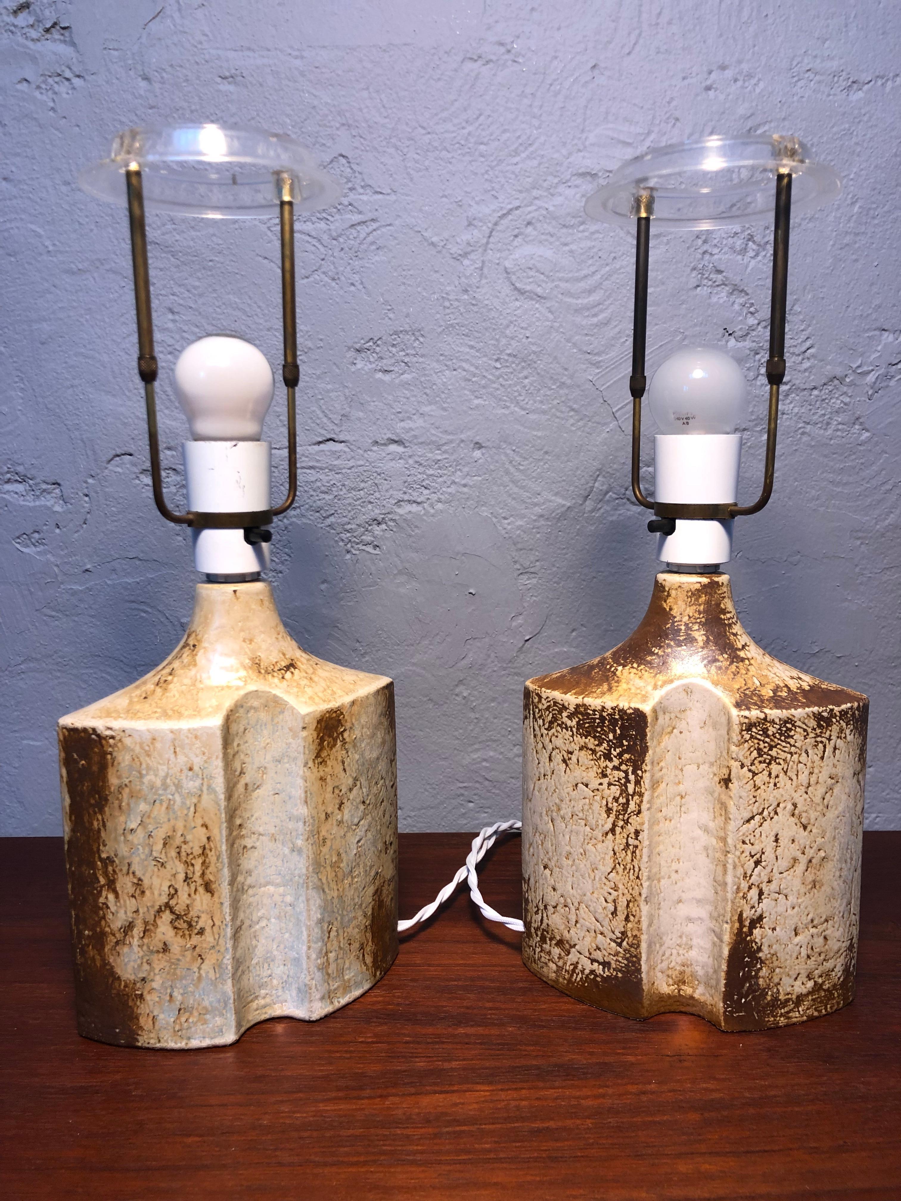 A vintage pair of brutalist pottery table lamps by Norwegian designer Haico Nitzsche for Søholm of Denmark. 
In 1973 Haico Nitzsche left Gustavberg of Sweden and moved to Rønne on the island of Bornholm Denmark where the Søholm factory was located