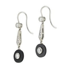 A vintage pair of onyx and diamond drop earrings