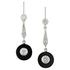 A vintage pair of onyx and diamond drop earrings