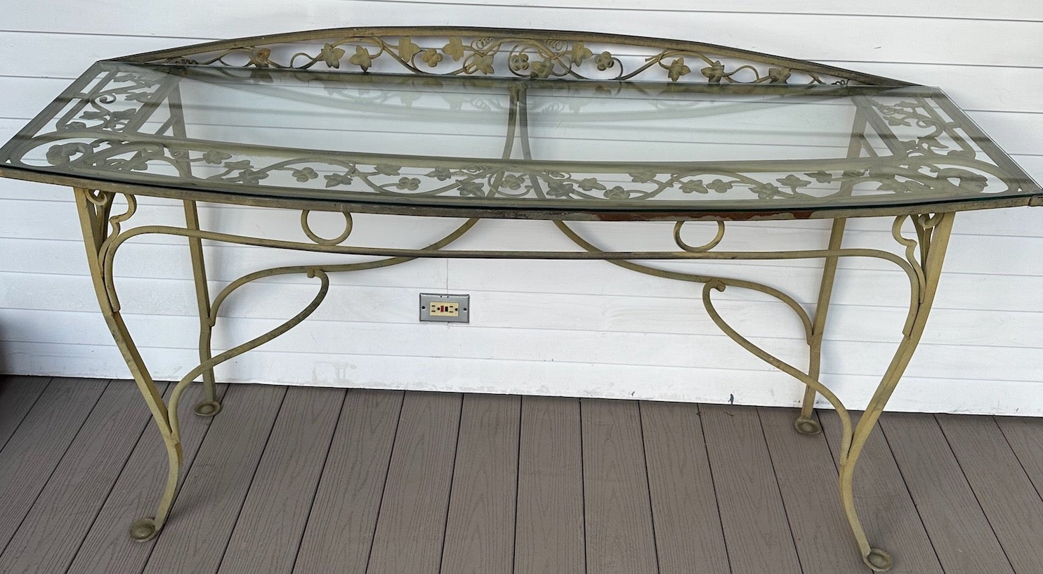 This is an Important vintage wrought iron and glass console table in the style of John Salterini. This exact table is shown in early Salterini catalogs and is called by the company  