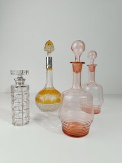 A Vintage Spirit Decanter Bottle in Colored Cut Crystal and Embossed Silver