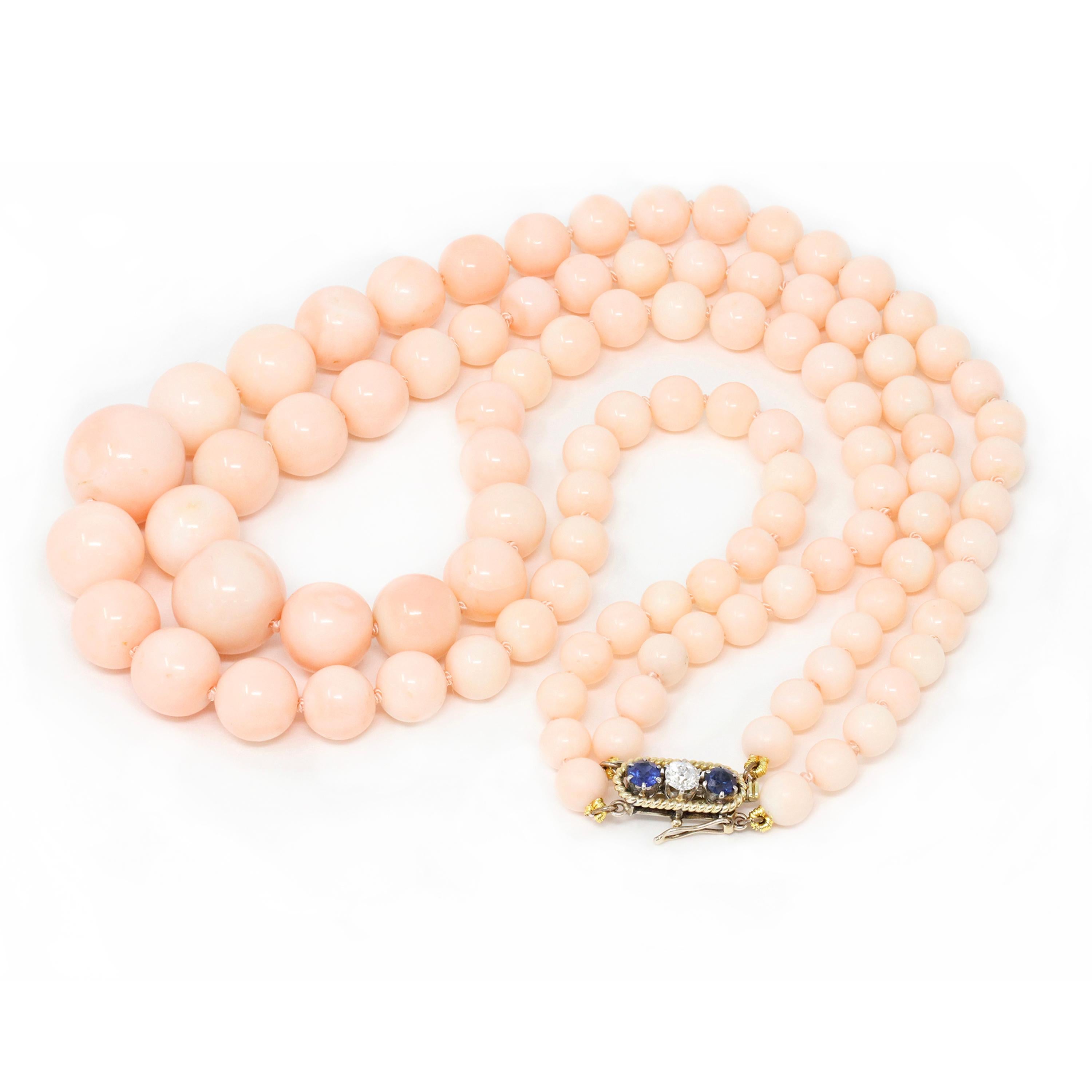 A Vintage Retro Double Strand of Angelskin Beads Necklace with a Diamond and Sapphires clasp. The rare Coral beads display an even blush light pink color, they are very well matched with minimal surface inclusions. The two strands of forty-nine and