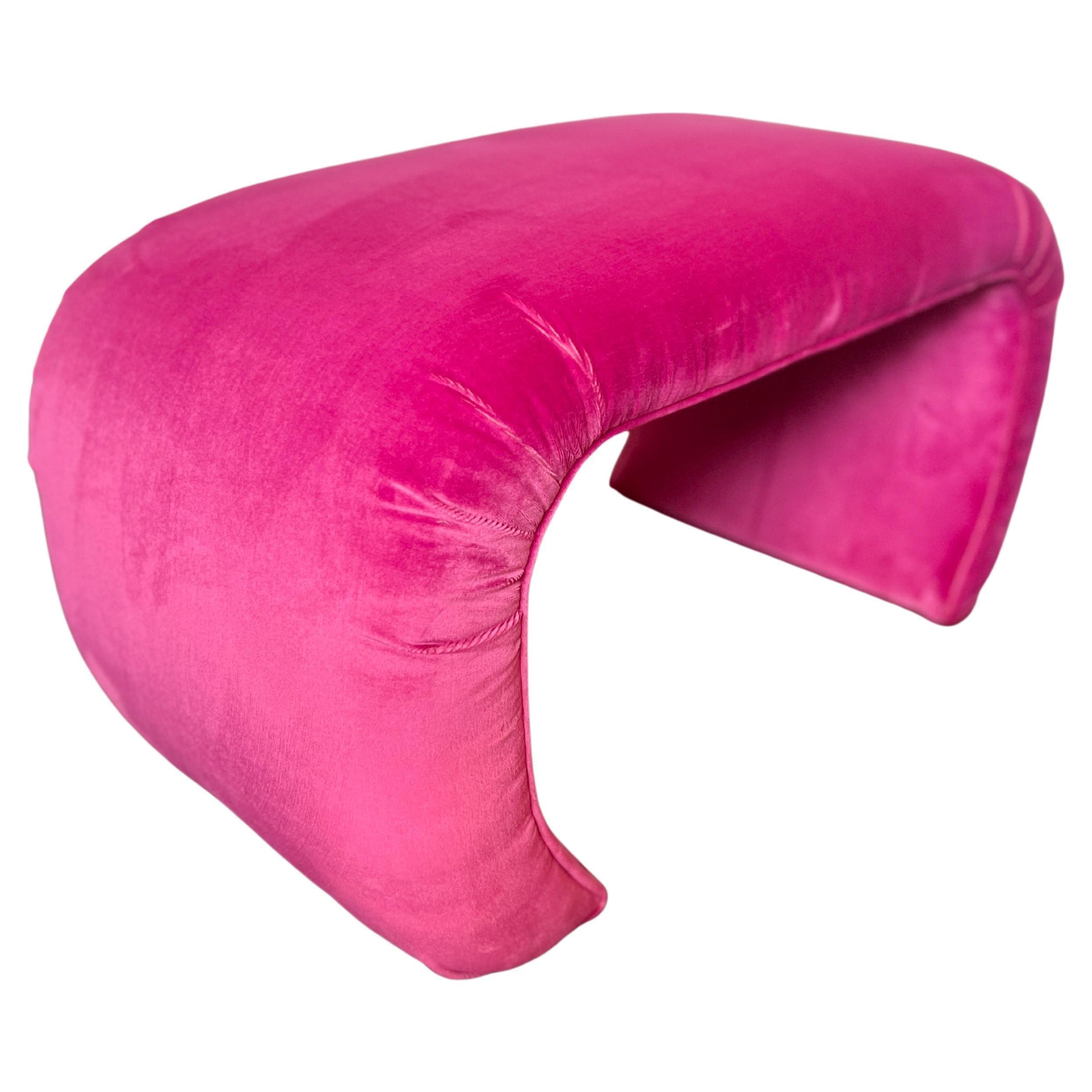 A vintage waterfall ottoman reupholstered in a hot pink performance velvet