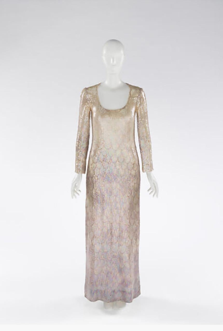A/W 1973 Halston sleeveless sequin 'scale' gradient gown. A-line tent scoop neck gown with full sequins throughout. Includes additional sequin allotment at interior hemline. Fully lined with nude semi-sheer lining. Pull-over gown with no closures.