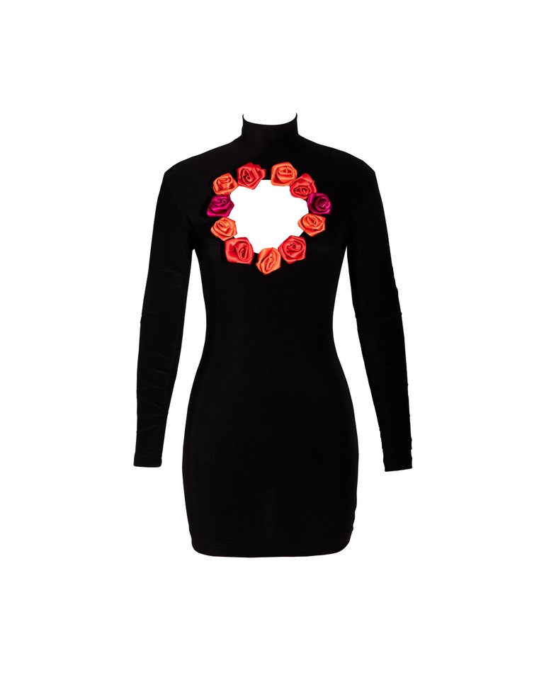 A/W 1992 Chantal Thomass black stretch jersey mini dress and leggings. Dress features circular cutout at chest adorned with roses. 3D roses on legs and chest are made of red leather and satin. Leggings have fleece lining. Leggings seen on
