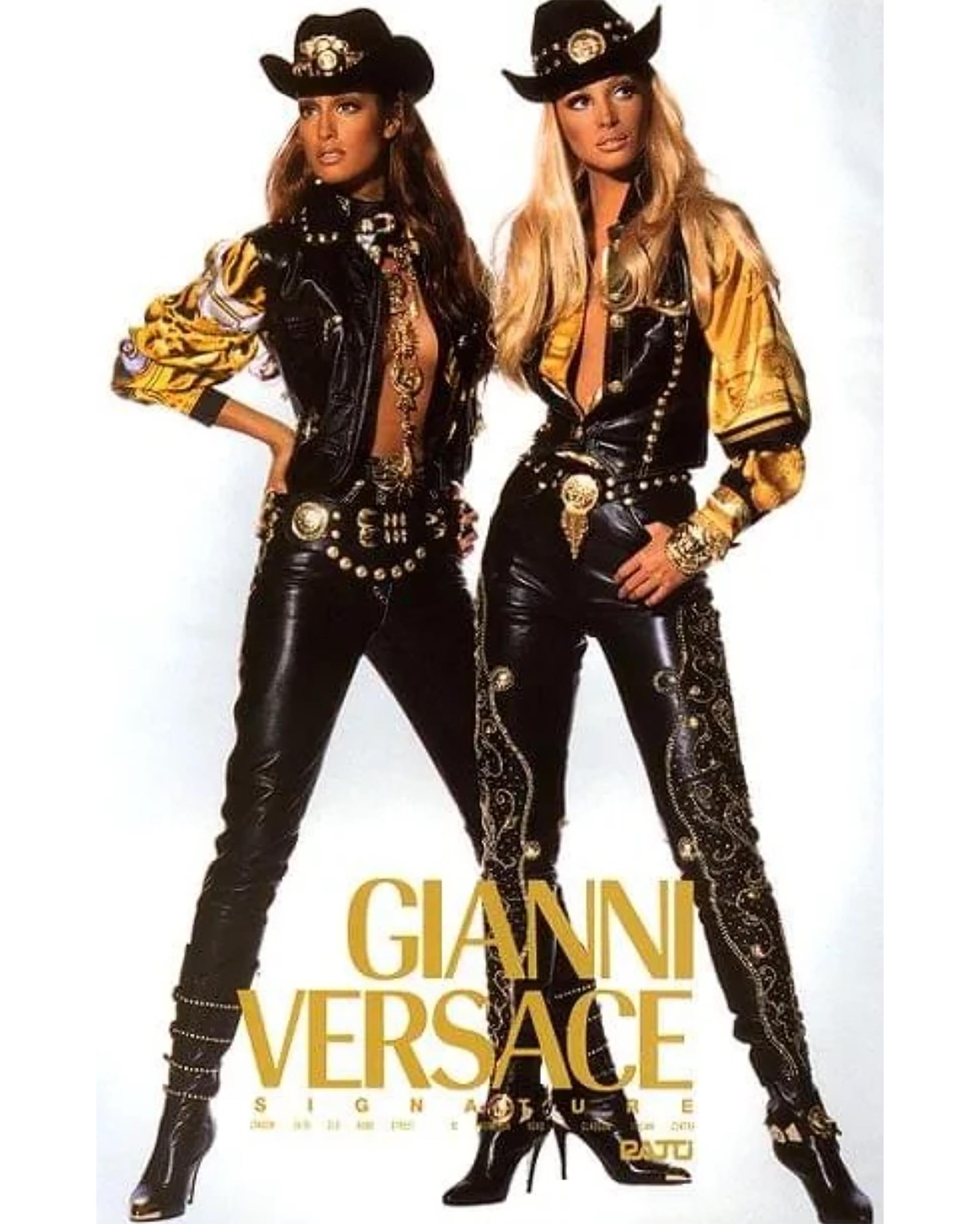 A/W 1992 Gianni Versace leather studded vest, pant and belt. Super iconic sleeveless zip-front vest with detailed studded front bust pockets. High-rise leather pants with gold studded details across the sides. Complete with oversized Gianni Versace