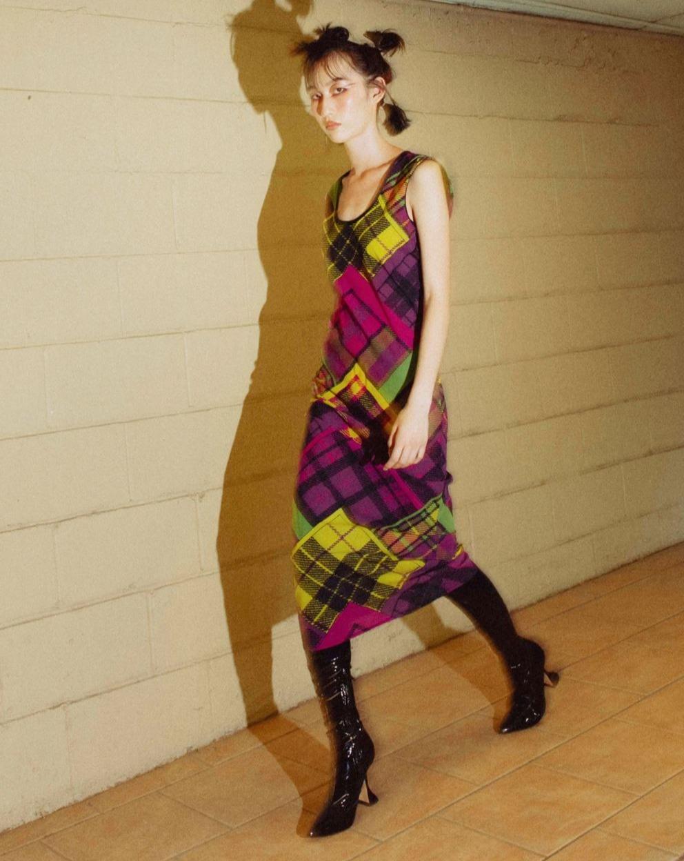 Versace scoop neck sleeveless midi dress. Plaid print in dark purples, yellow and green hues. Back zip enclosure. Fabric feels like light silk and nylon. In very good vintage condition, with very minor spot on back; pin sized holes in back (not
