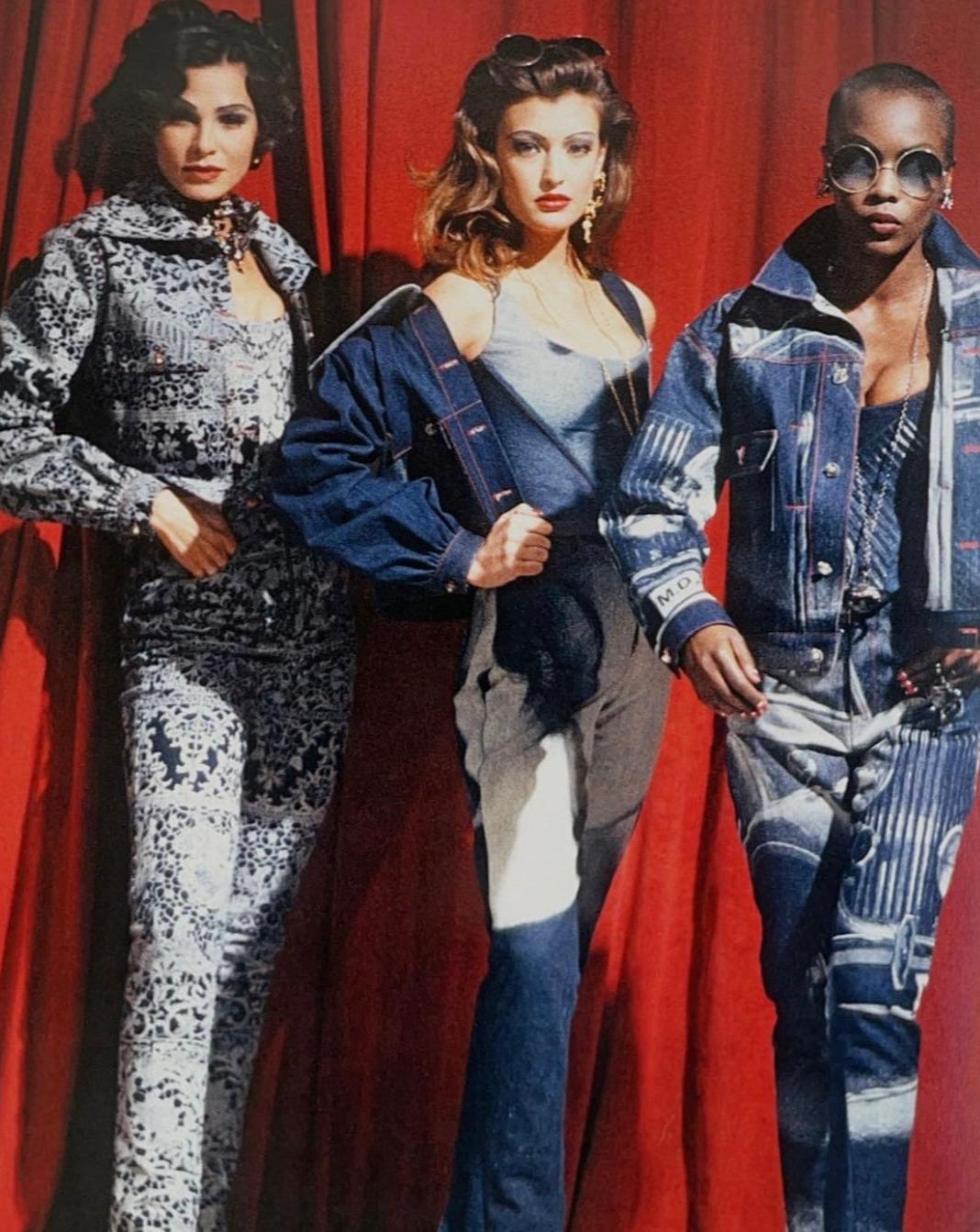 A/W 1992 Vivienne Westwood 'Always on Camera' Collection Rolls Royce printed jacket and jeans set. Denim printed jacket with red contrast stitching throughout. Signature Vivienne Westwood 'orb' buttons. High-rise wide leg denim pants feature