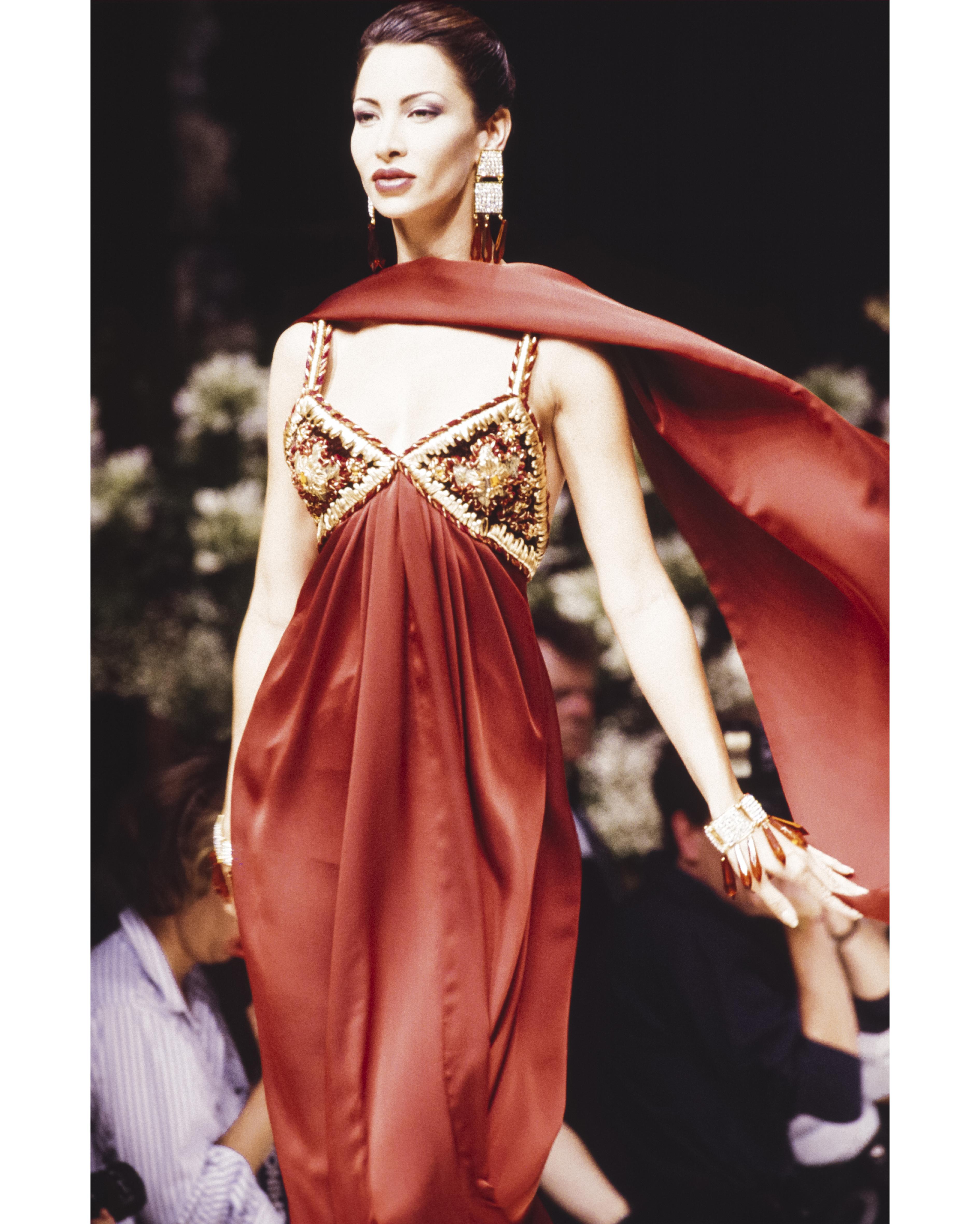 A/W 1993 Givenchy Haute Couture embroidered velvet midi dress. Red-orange fitted dress with gold and floral pattern embroidered bust, utilizing raffia and velvet with center orange oversize rhinestone detail. Sleeveless dress with back snap