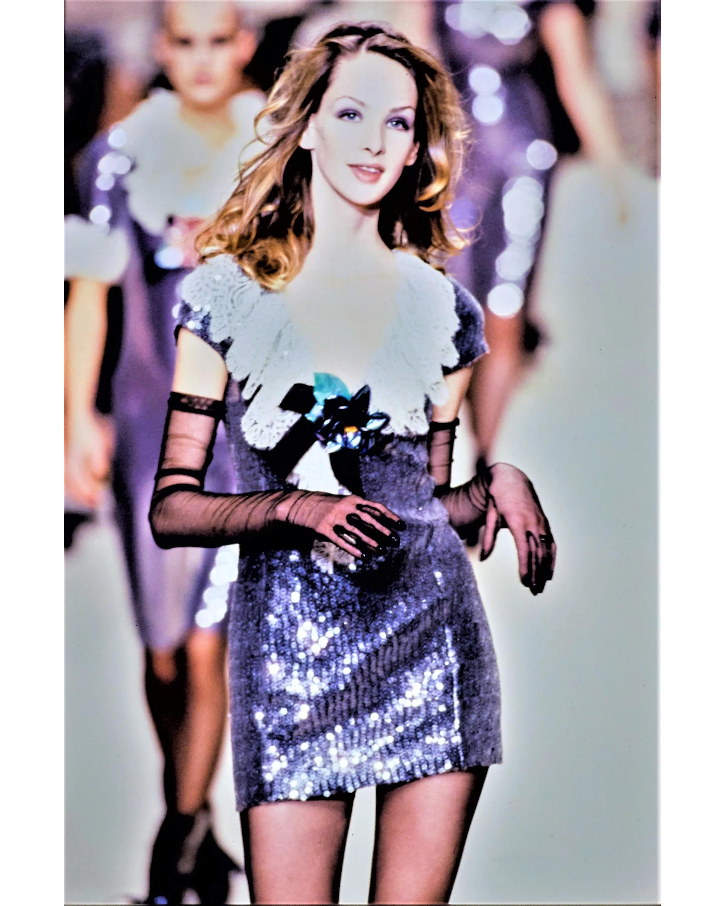 A/W 1994 Chanel sequin dress with lace bust and removable iridescent camellia brooch. Cap sleeve above-knee dress with lace and bow details at bust. As seen on the runway (Look 175). 