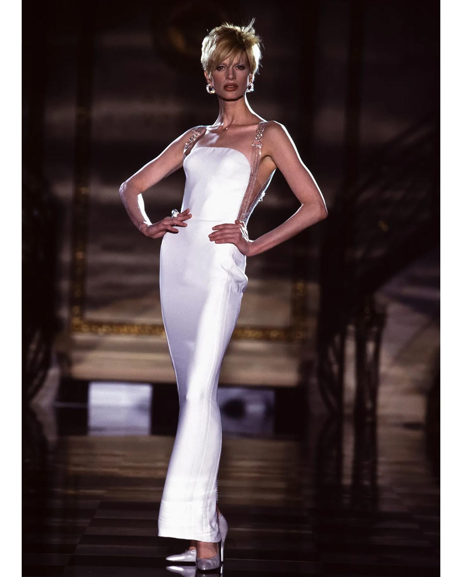 A/W 1995 Atelier Versace Haute Couture ecru silk and clear vinyl gown with signature Medusa clasp straps. Off-white silk gown with stitched clear vinyl straps and bust, featuring gunmetal silver tone and clear vinyl Versace Medusa strap motifs.
