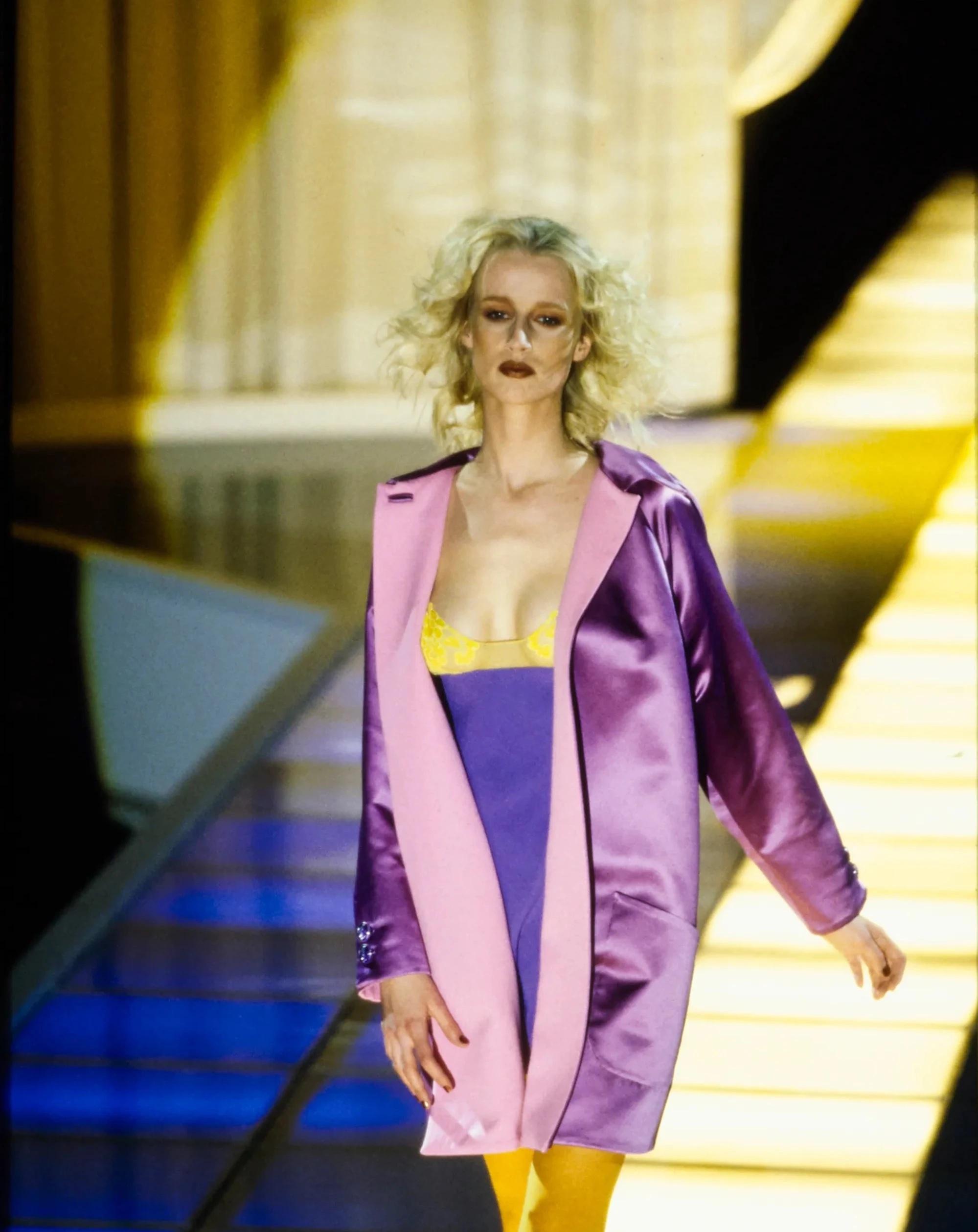 A/W 1996 Gianni Versace silk mini dress in purple and marigold color way. Yellow lace bodice and hem. Mesh paneling and rhinestone Versace Medusa Head adornments on silk chiffon straps. As seen on the runway (Look 66) and on worn by Foxy