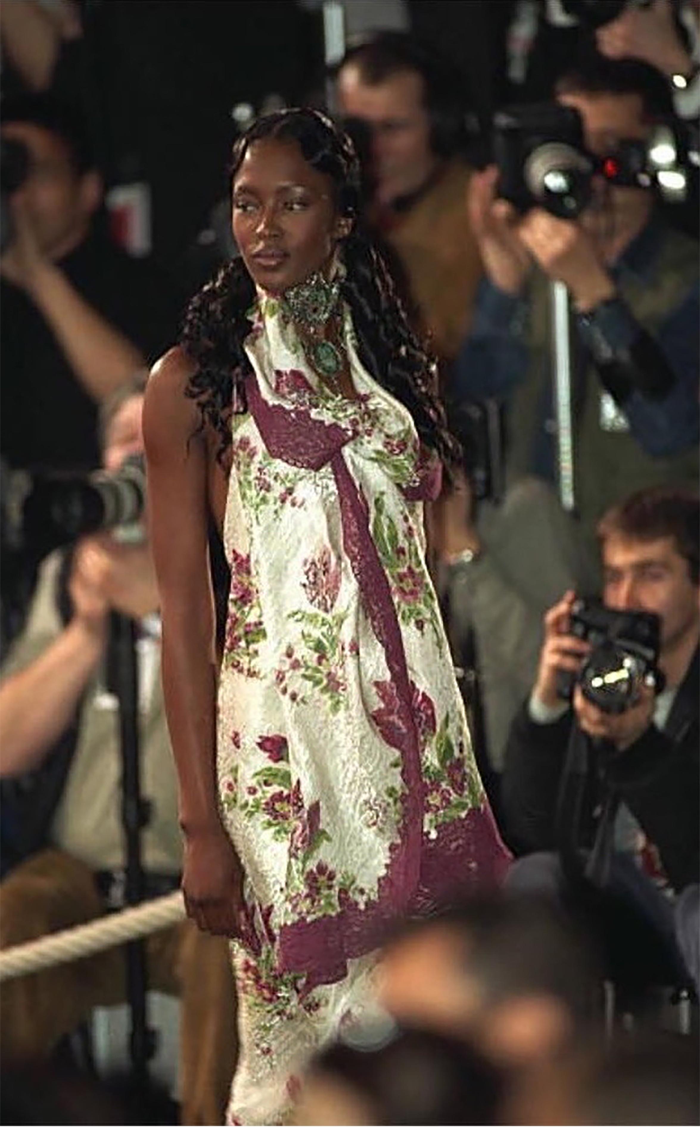 A/W 1998 Christian Dior by John Galliano white floral print slip gown with purple lace details. Sleeveless bias cut gown with purple and green floral print throughout, with subtle silver floral print layered underneath. Same dress seen on Naomi