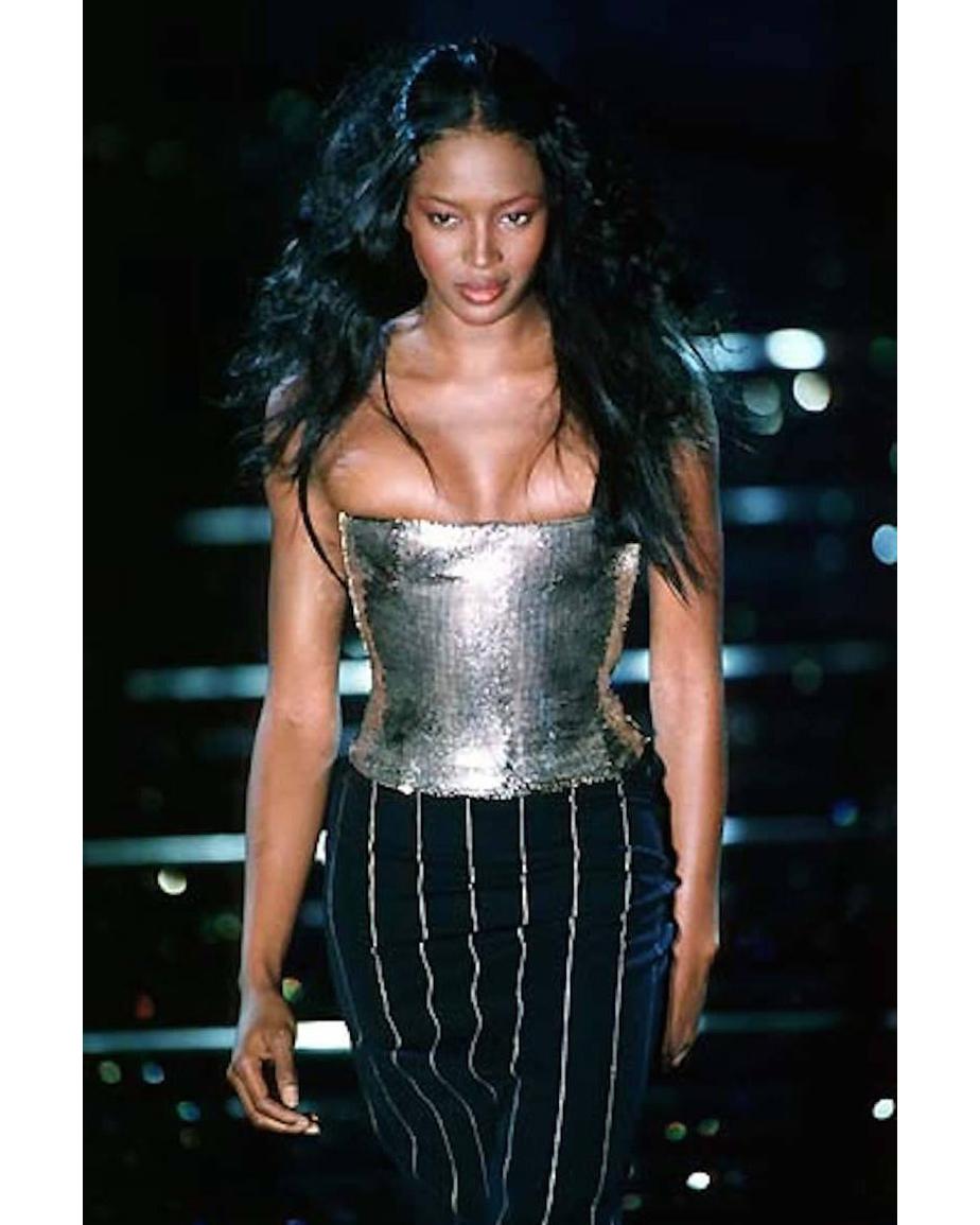 A/W 1998 Gianni Versace silver oroton chainmail corset. Bright fully chainmail corset with built-in boning and silk lining. Hidden side zip closure. As seen on the runway on Naomi Campbell; matching pinstripe skirt available in separate listing to