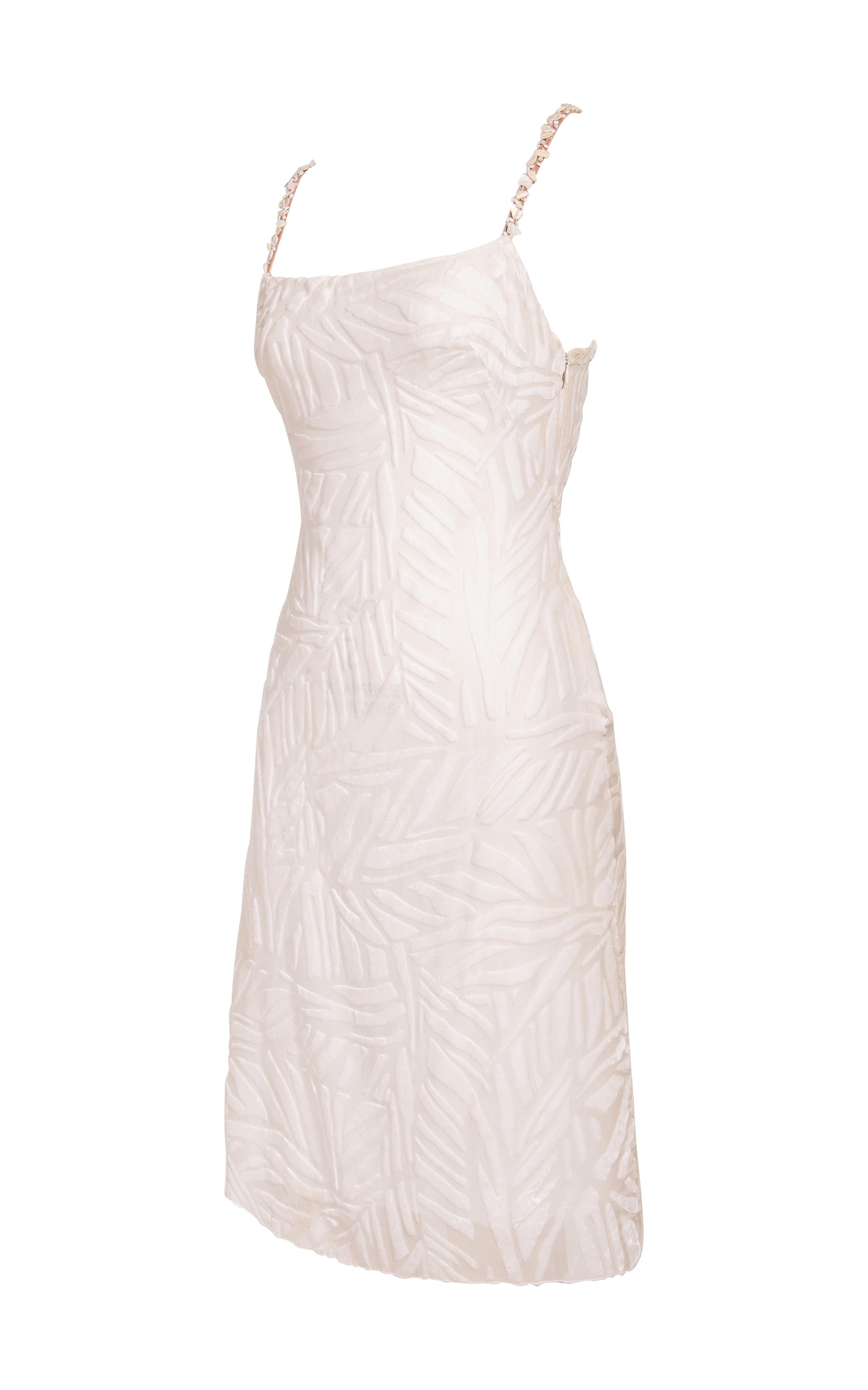A/W 1999 Gianni Versace white silk velvet burnout mini dress with shell and beaded embellished straps. Sleeveless dress with velvet leaf print throughout. Fitted bodice with slightly flared hem.