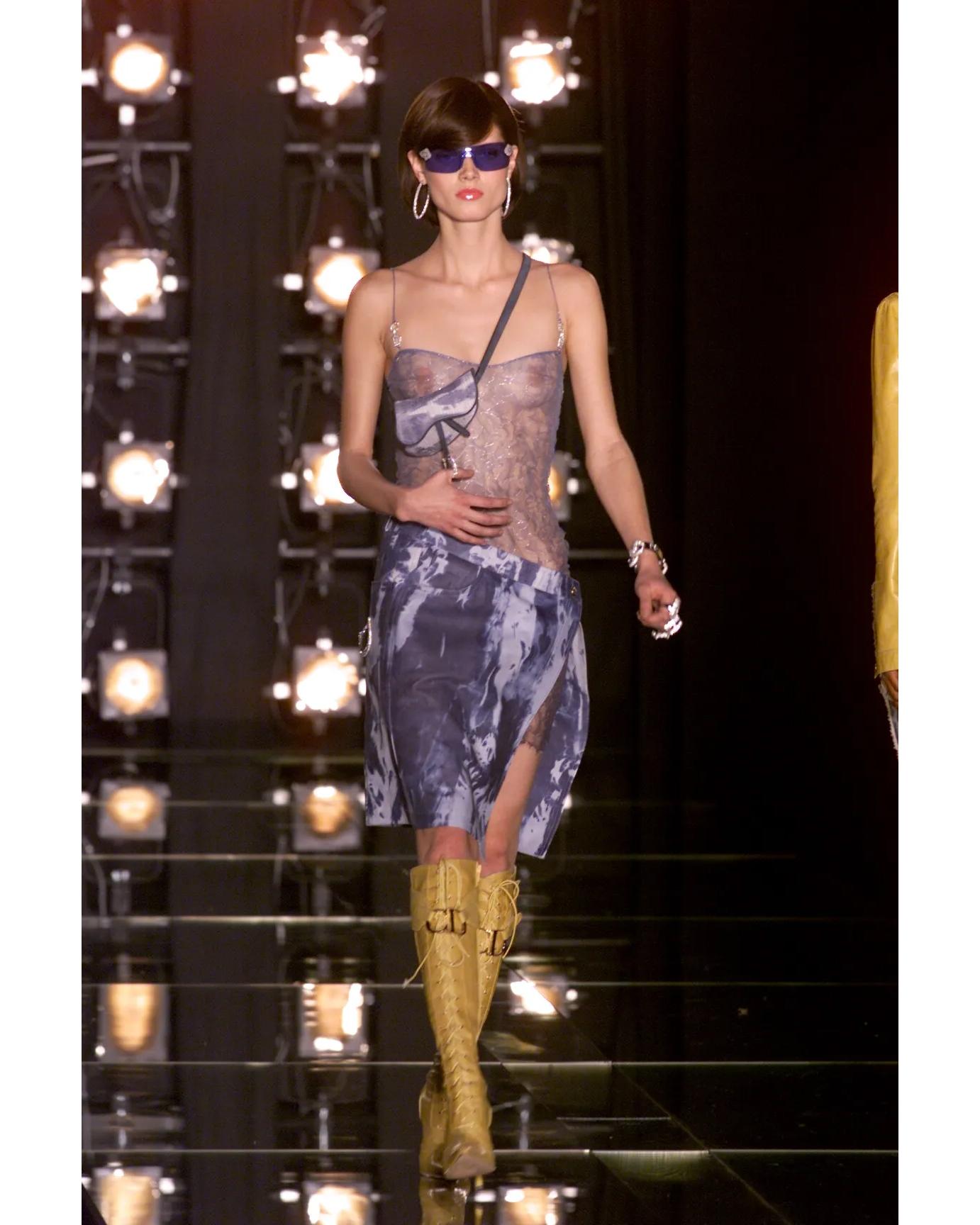 A/W 2000 Christian Dior by John Galliano denim tie-dye wrap skirt. Vibrant light blue and medium blue wash tie-dye patterned skirt with asymmetrical wrap structure. Interior button closure to create wrap effect, and five gold-tone stamped 'Christian