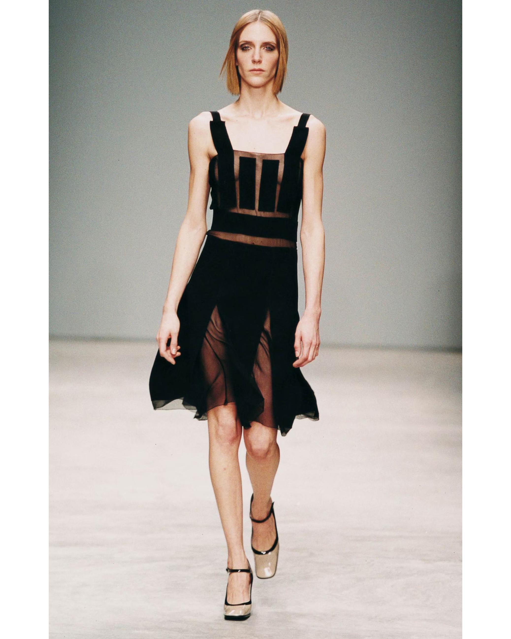 A/W 2001 Prada by Miuccia Prada knee length black dress with semi-sheer silk chiffon accents. Delicate silk chiffon paneling is alternated with soft virgin wool to create a sexy yet chic fit. Square neckline, sleeveless dress with A-line skirt. As