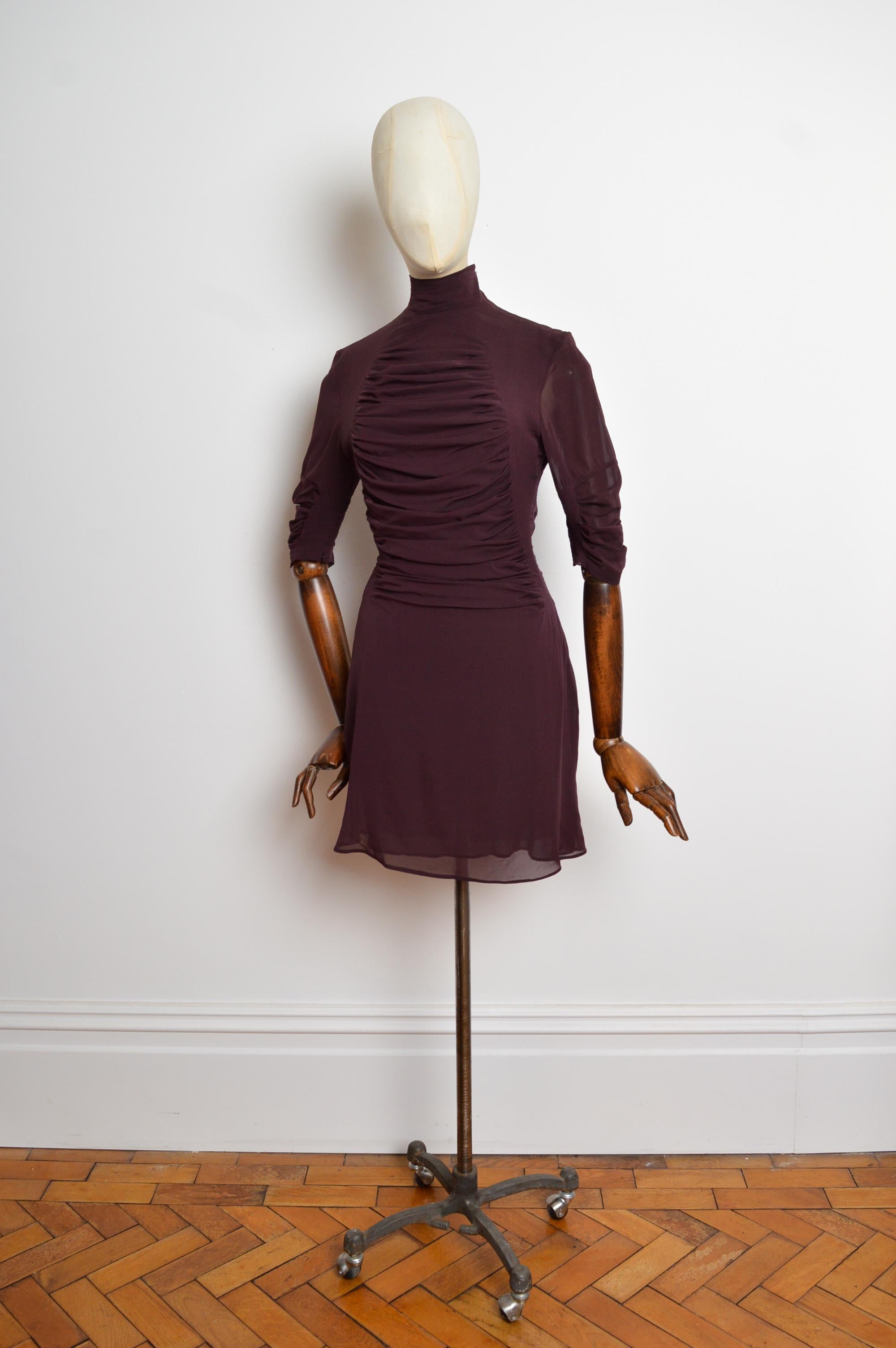 A/W 2001 Yves Saint Laurent by Tom Ford Plum Silk high Neck mini Dress 
Autumn / Winter 2001 YSL Rive Gauche Mini dress by Tom Ford. 
Featuring a high neck cut, pleated Silk with draping detail and 3/4 Sleeves. Sexy and Timeless. 
Size; Recommended