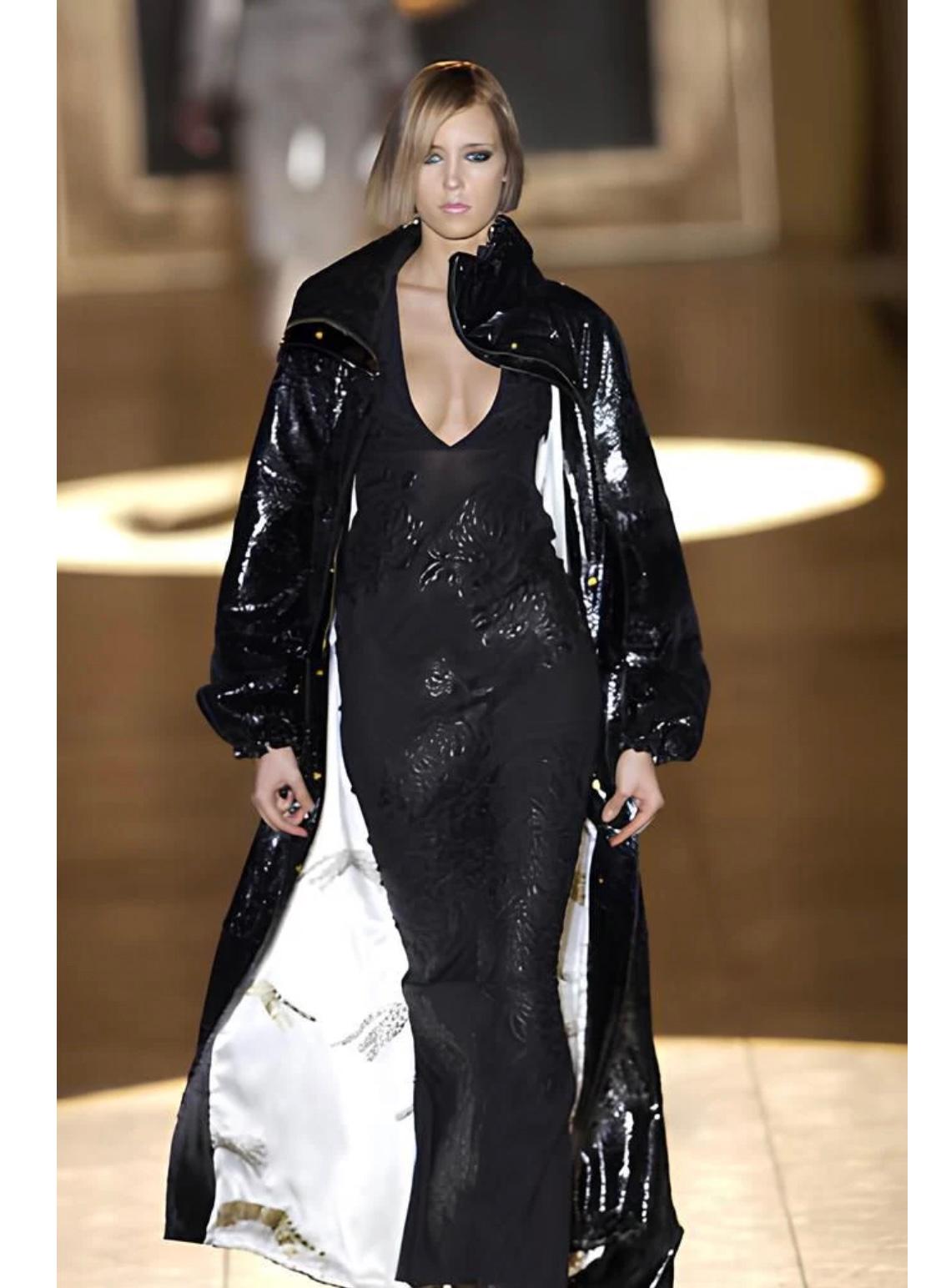 A/W 2002 Roberto Cavalli runway leather floral patches sheer dress

Runway A/W 2002 Roberto Cavalli sheer dress featuring leather floral patches cascading across the body. The long, column-like silhouette and transparency contrast with the tactile