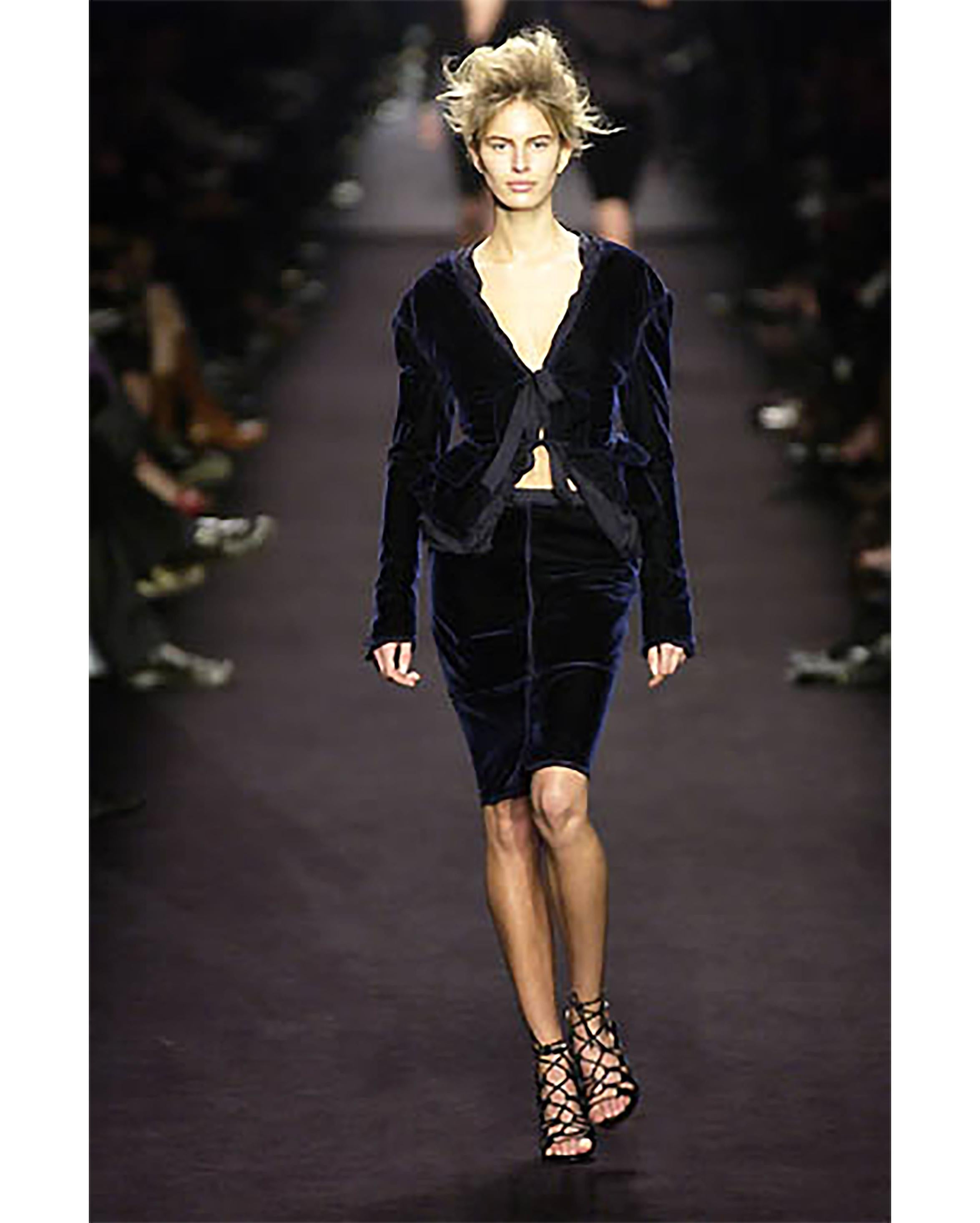 A/W 2002 Yves Saint Laurent by Tom Ford deep sapphire velvet suit set that ties in front and back with pale purple silk ribbons, with special tied mesh lining around the entire jacket, and deep openings in sides that reveal silk paneling. Skirt hits