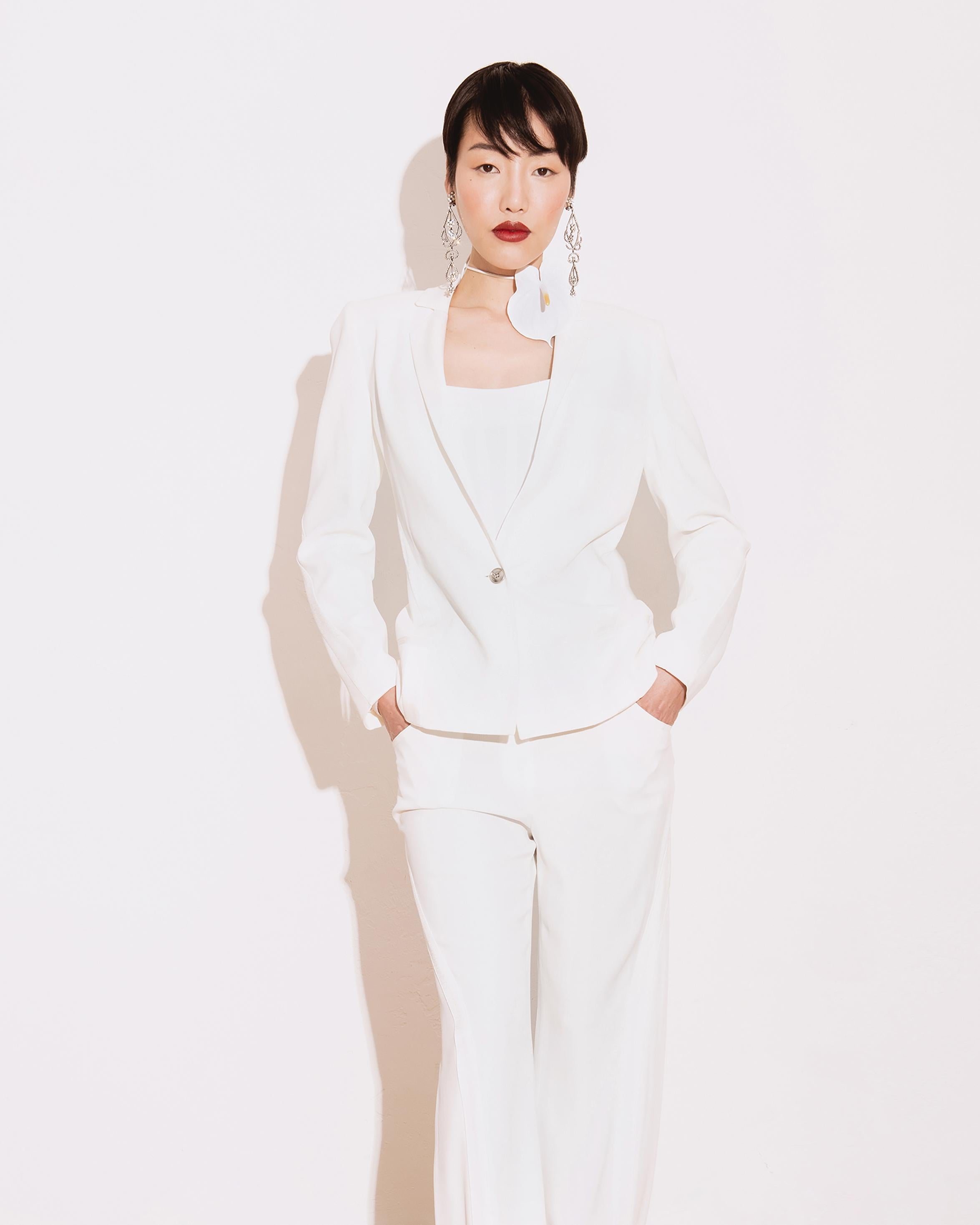A/W 2004 Christian Dior by John Galliano white satin smoking pant suit set with curved silk paneling. White blazer jacket with single stamped Dior button and mid-rise trousers with very slight flare at hem. 

Measurements:
JACKET
Pit to Pit: 17
