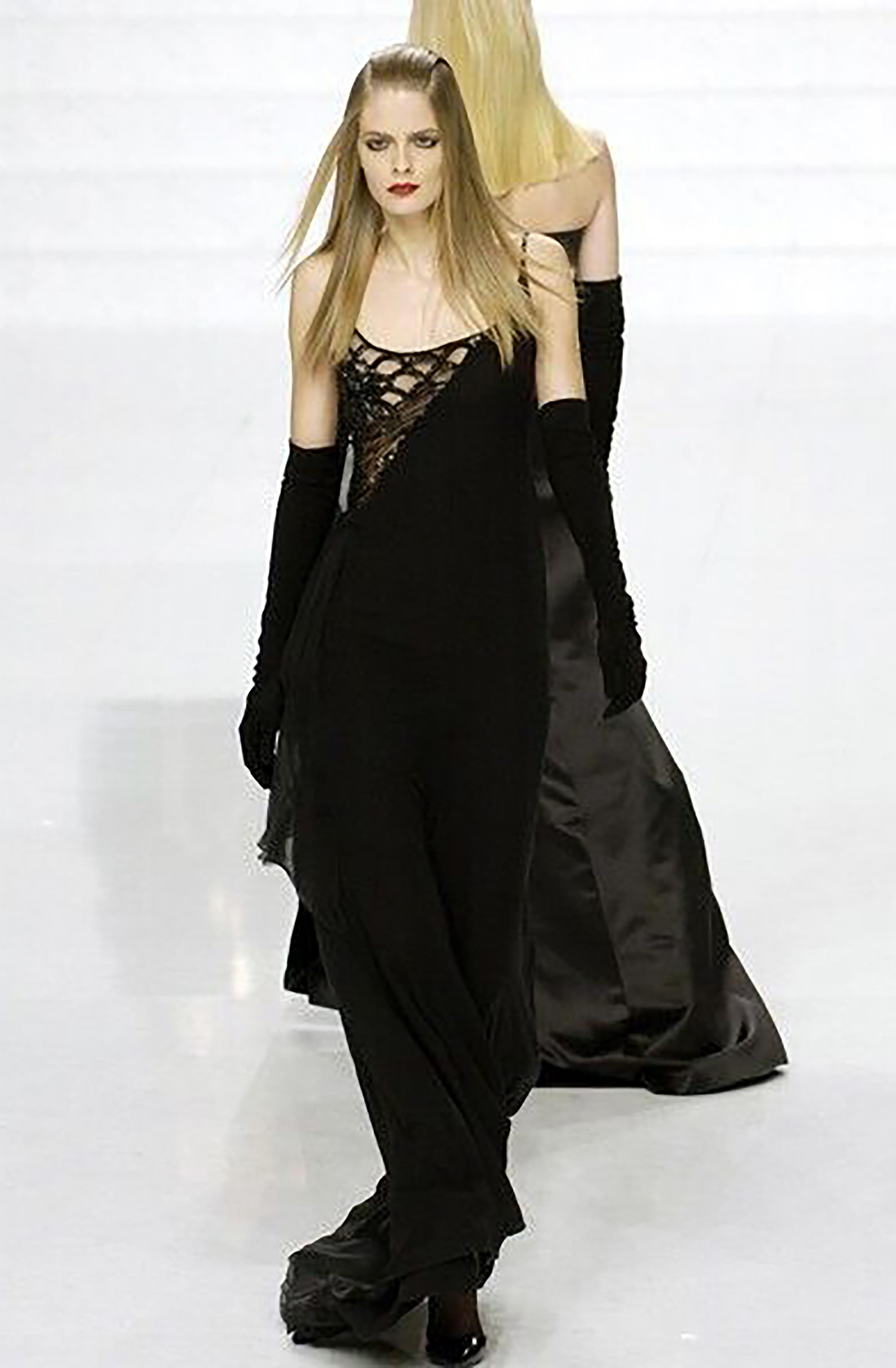A/W 2006 Valentino black silk embellished floral asymmetrical gown. Heavily embellished silk crepe sleeveless gown with asymmetrical floral and scalloped pattern semi-sheer mesh bust and sides. Black drape paneling around right side. Low back with