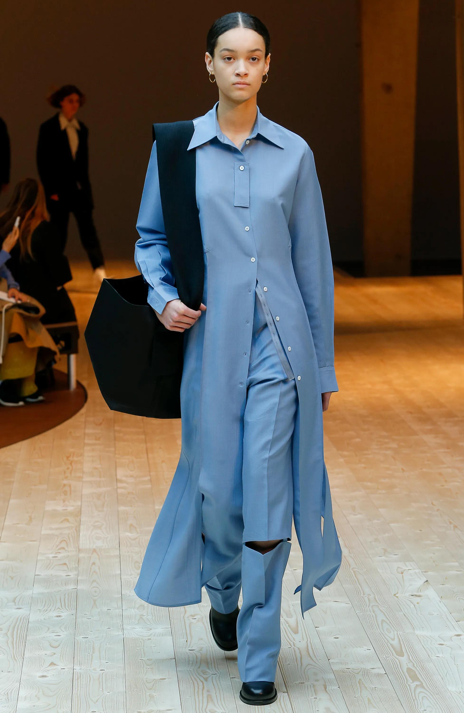A/W 2017 Céline by Phoebe Philo button-up light blue shirt dress / top. Long sleeve dress with deconstructed hanging rectangular detail at bust. Features high open slits at sides that are reminiscent of 1960's 'carwash' fringe. Can be utilized as