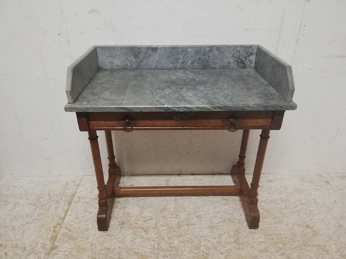 A W Pugin. Stamped Gillows 
A Gothic Revival oak marble top washstand with decorative iron escutcheon and brass drop handles to the drawer and carved florets to the feet.