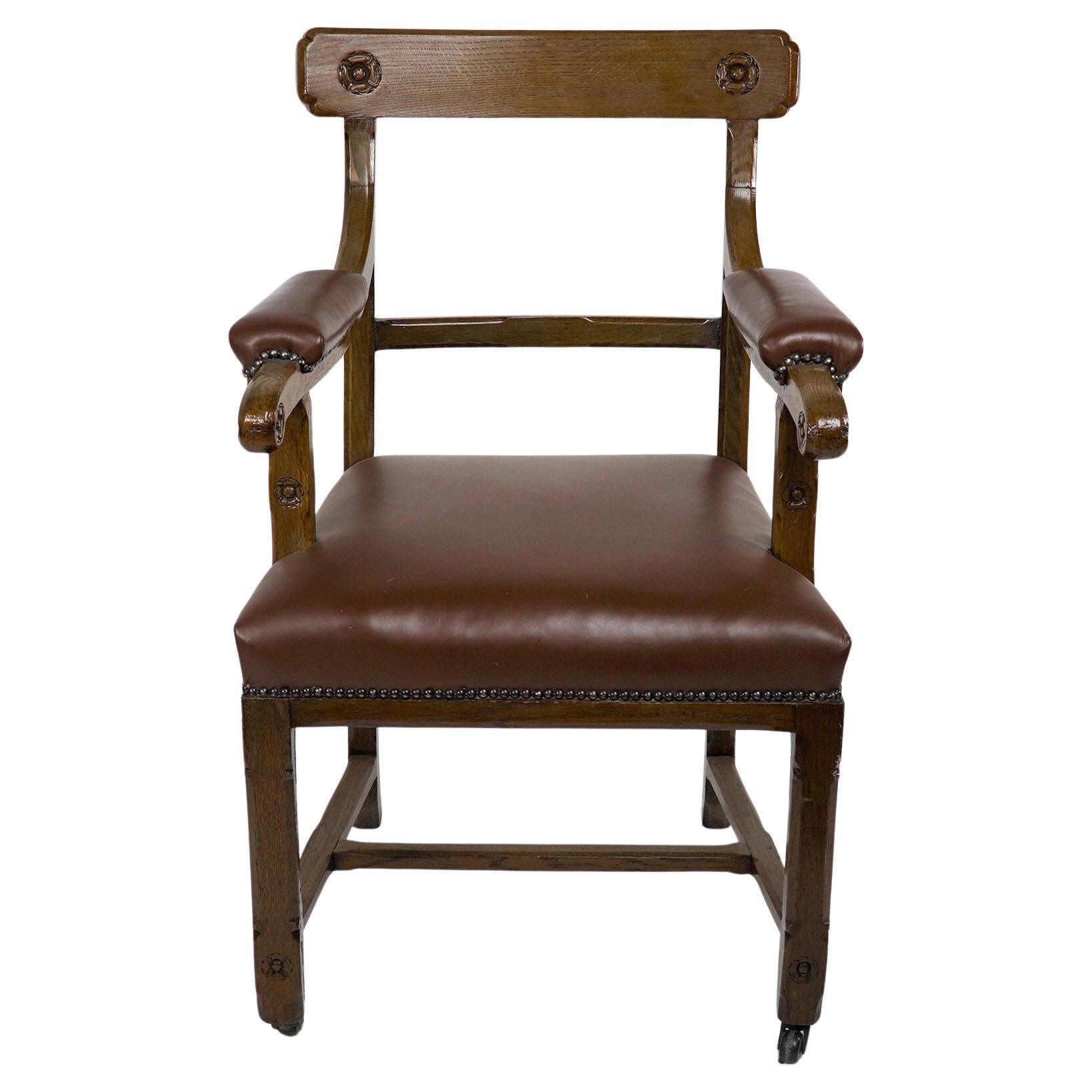 A W N Pugin, probably made by Gillows of Lancaster for the House of Lords London. A Gothic Revival oak armchair with carved rosettes to the headrest, and each side of the arms, and unusual to this model there are two small carved rosettes below the