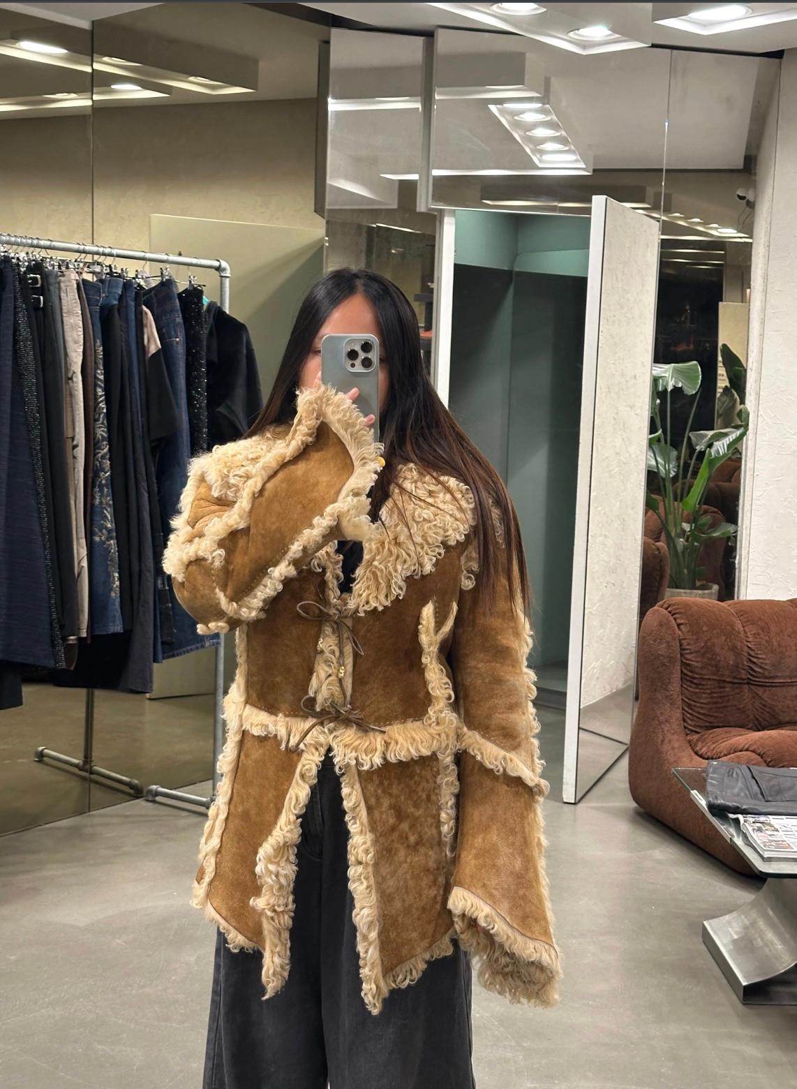 1999 Roberto Cavalli shearling patchwork coat

This exceptional Roberto Cavalli coat from 1999 features a luxurious patchwork construction of tan leather and cream shearling. Designed in an oversized fit, it showcases a dramatic wide collar, exposed