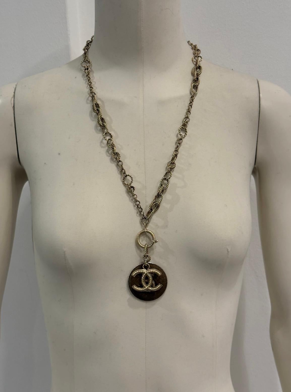 A/W2013 Chanel N°5 collar de cadena de oro

De la colección Otoño/Invierno 2013, este collar Chanel presenta una atrevida cadena dorada adornada con dos charms icónicos: el logotipo CC entrelazado y un medallón redondo grabado con el número 5, un