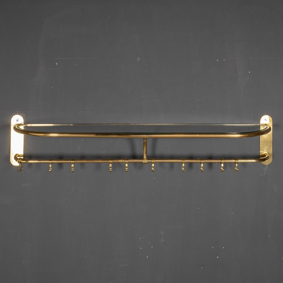 An unusual coat rack with brass rings to hang garments and a glass shelf for hats or accessories fabulous for a dressing room or hallway.

CONDITION
In Good Condition. (please refer to photographs)

SIZE
Height: 30cm
Width: 155cm
Depth: 30cm