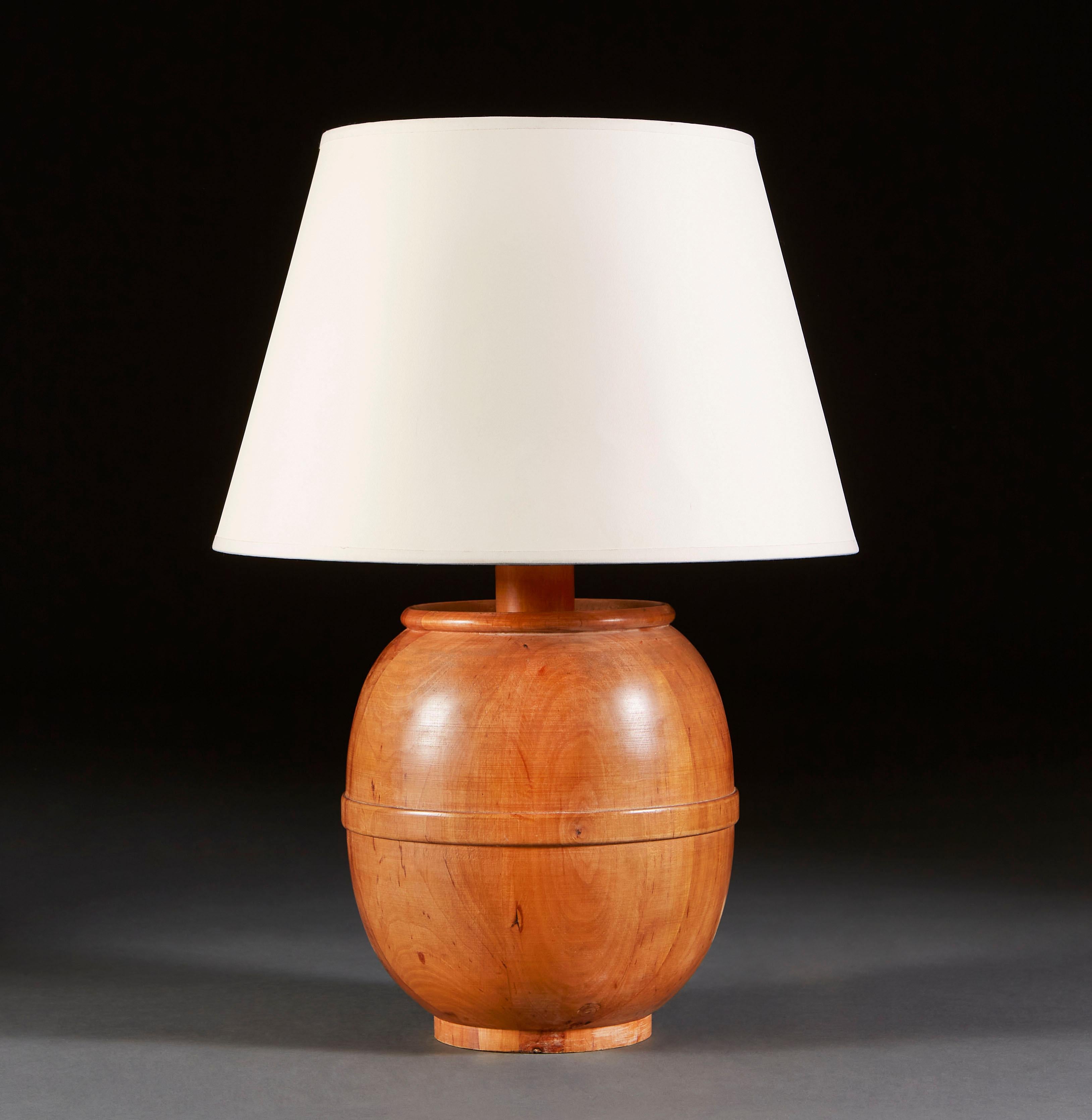A mid century walnut lamp in the form of a barrel, with strap carved around the waist.

Currently wired for the UK.

Please note: lampshade not included.
