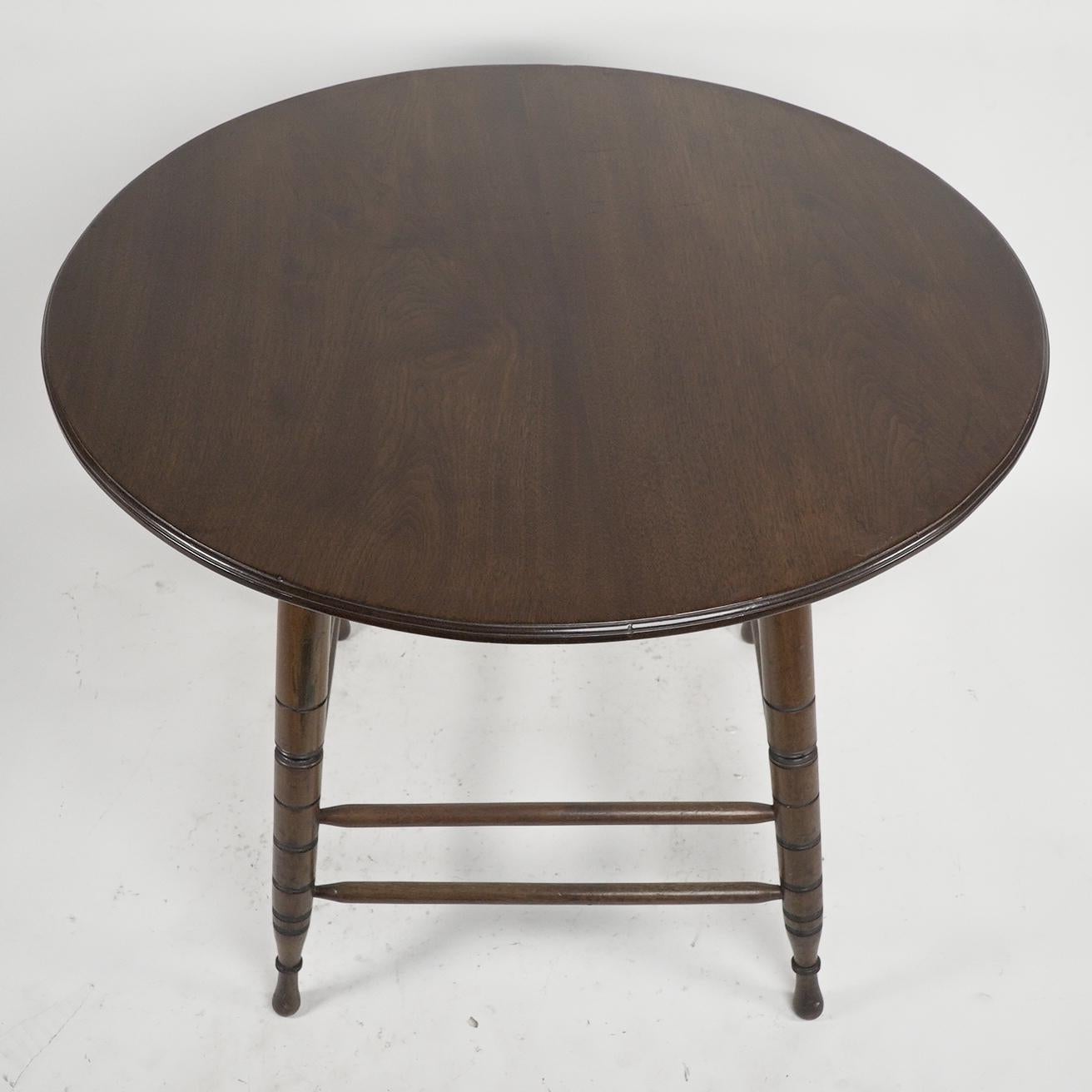English Aesthetic Movement Walnut centre table with incised circular details to the legs For Sale