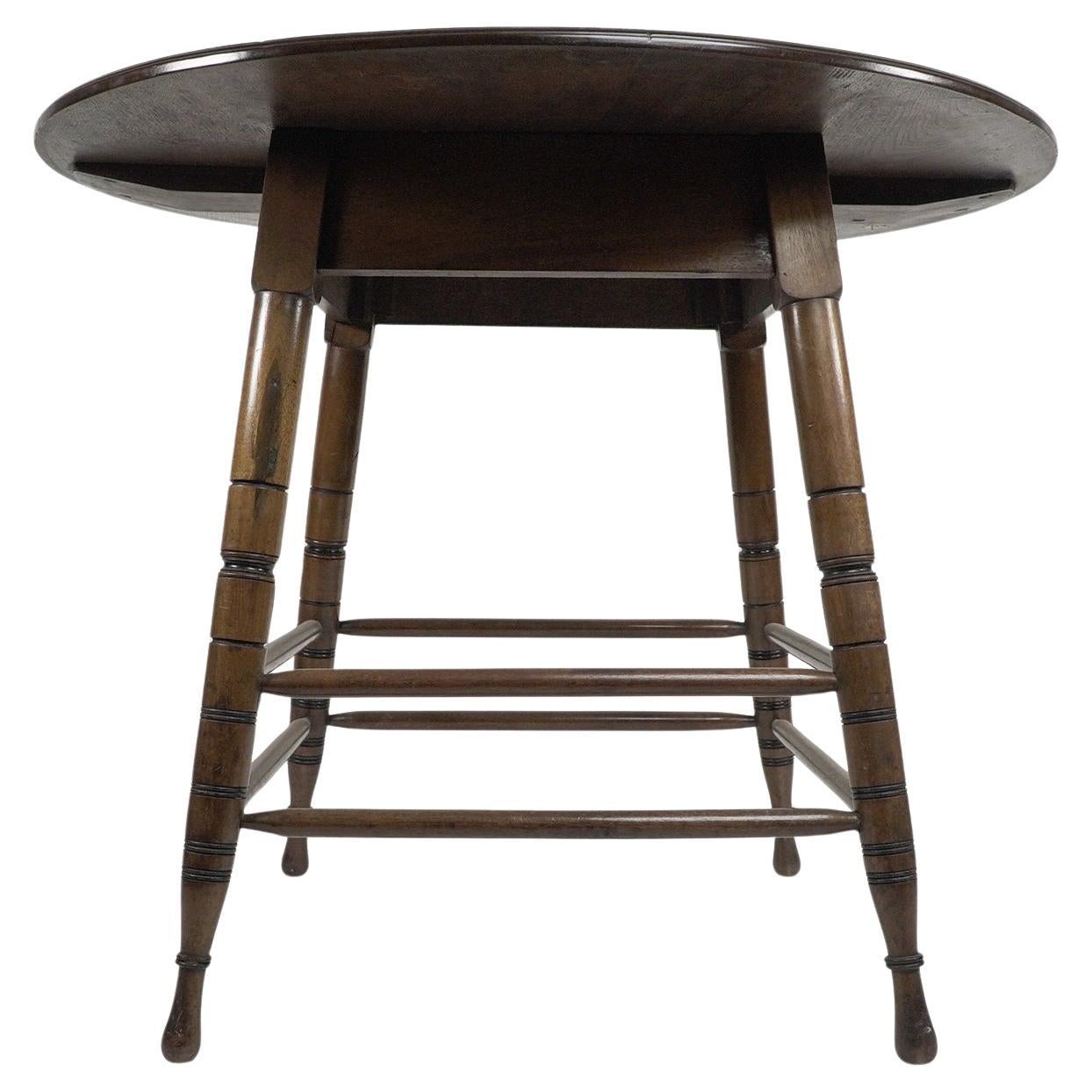Aesthetic Movement Walnut centre table with incised circular details to the legs For Sale