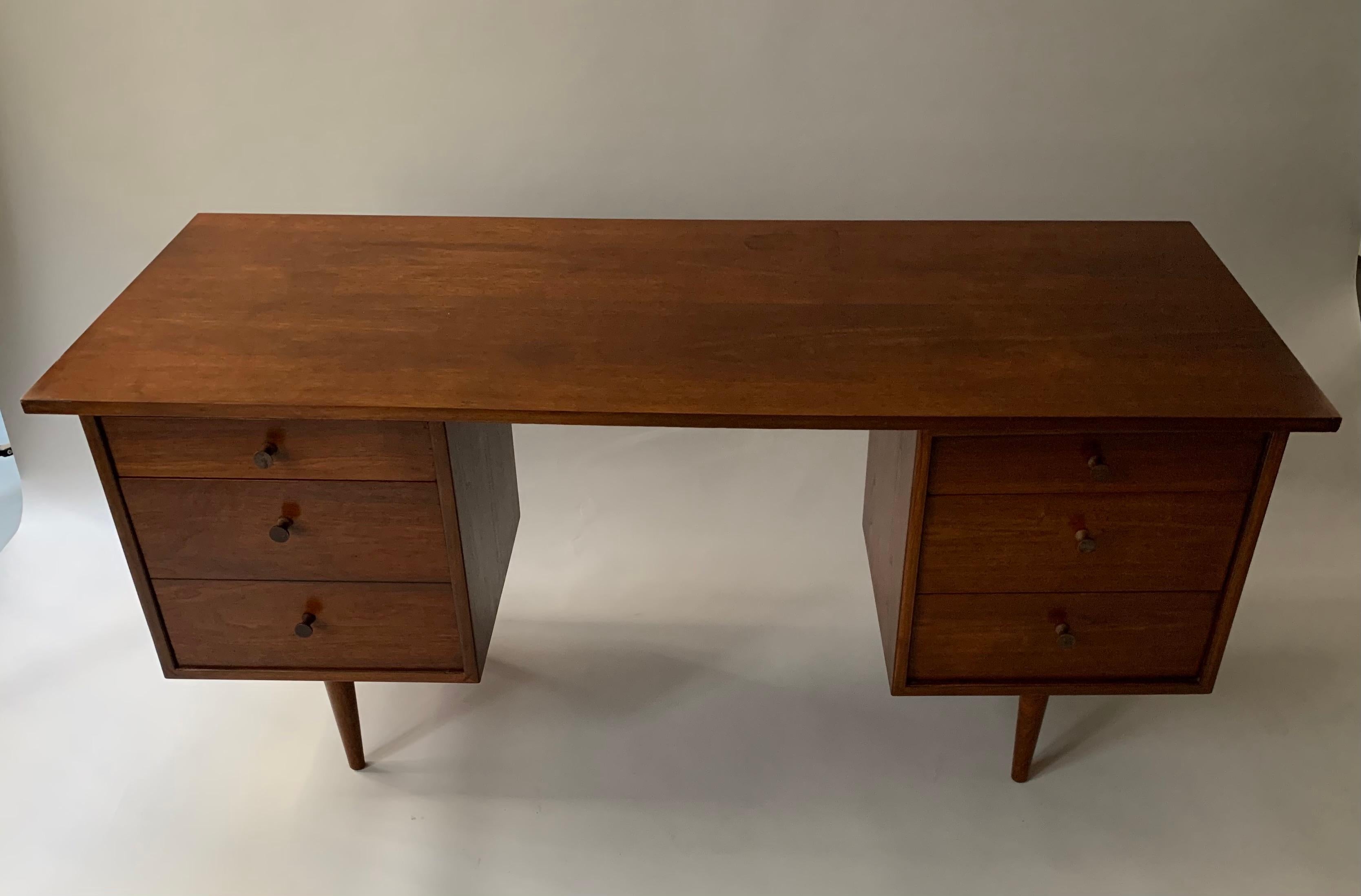 Walnut desk by renowned painter and sculptor, Richard Artschwager, who in 1953 designed a small collection of furniture in New York City. These pieces are scarce, as production and scope of design were exceedingly limited. 
Richard Artschwager