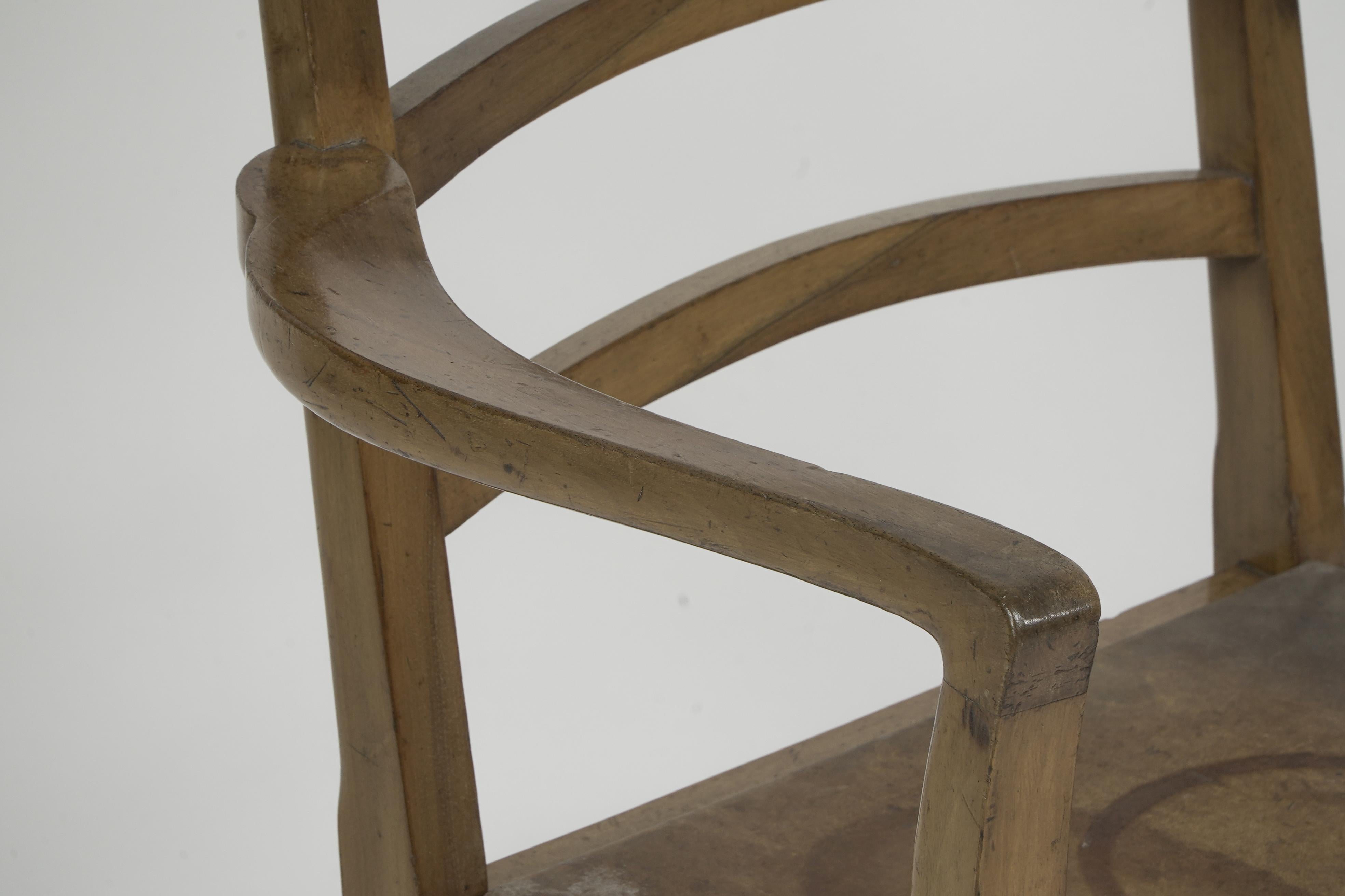 Walnut Heals attr, A walnut desk chair or armchair with a rounded top and ladder back. For Sale