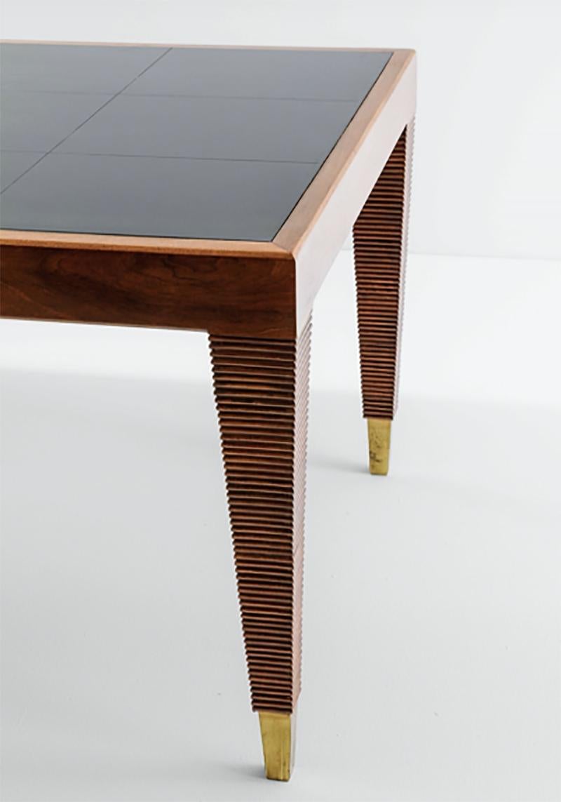 A walnut console table designed by Gio Ponti. Having a grid etched into the glass top with ribbed legs terminating in brass sabot. Designed for the 
