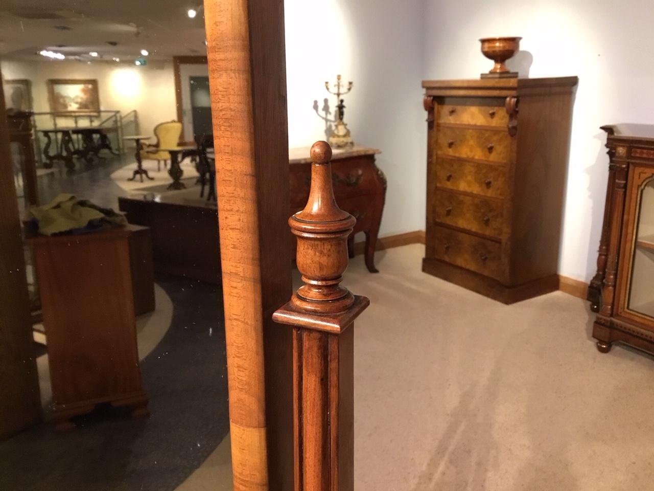 A walnut Queen Anne style antique cheval mirror. Having a rectangular mirror housed in a block moulded walnut shaped frame with recessed walnut upright supports, turned finials and brass handles which adjust the tilt of the mirror. The whole