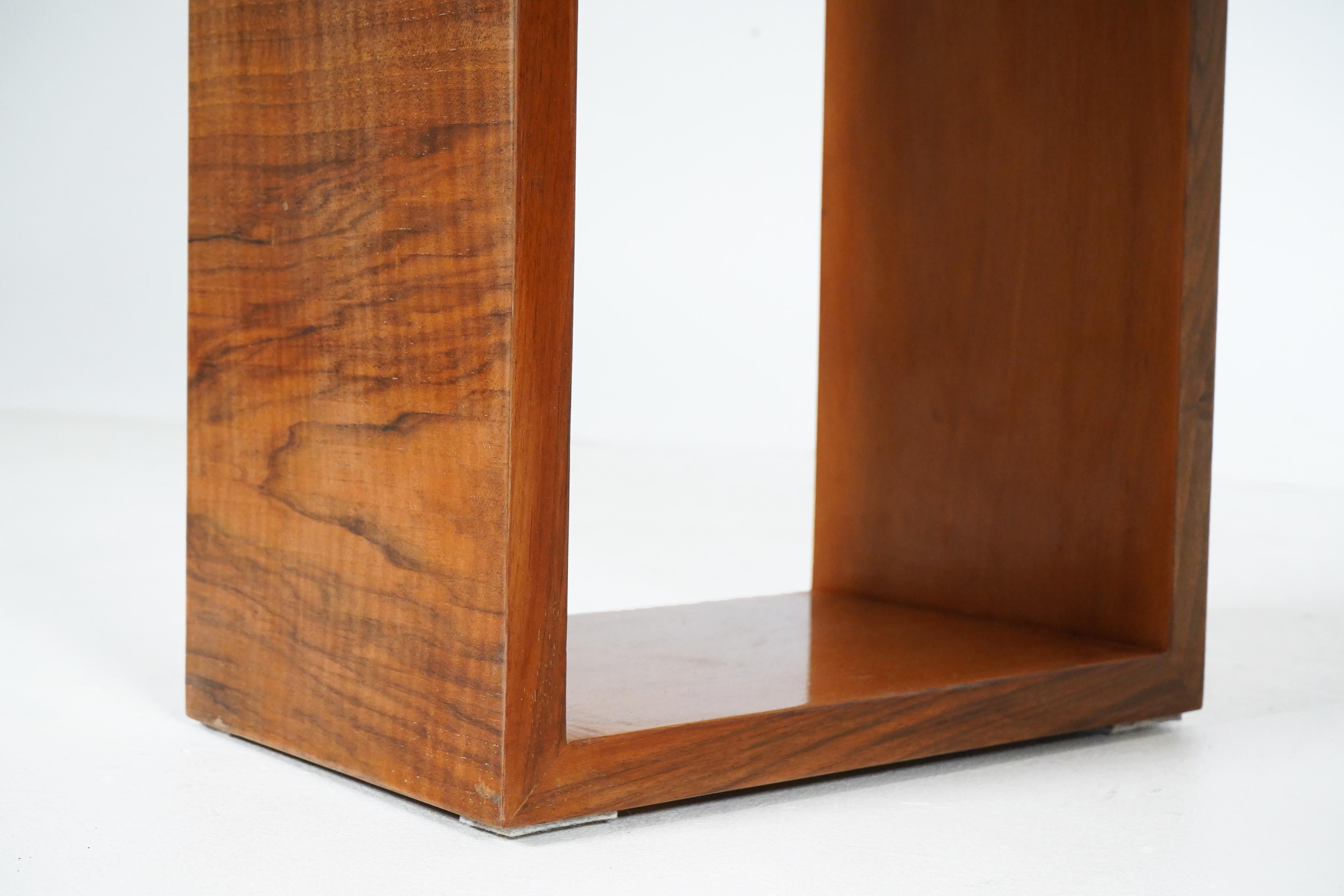 This dramatic 1960s console features walnut veneer and a cantilevered form. During the 1960s and 1970s, Hungarian furniture makers were encouraged to create simple, modern designs that could be mass-produced. They were intended to compete with