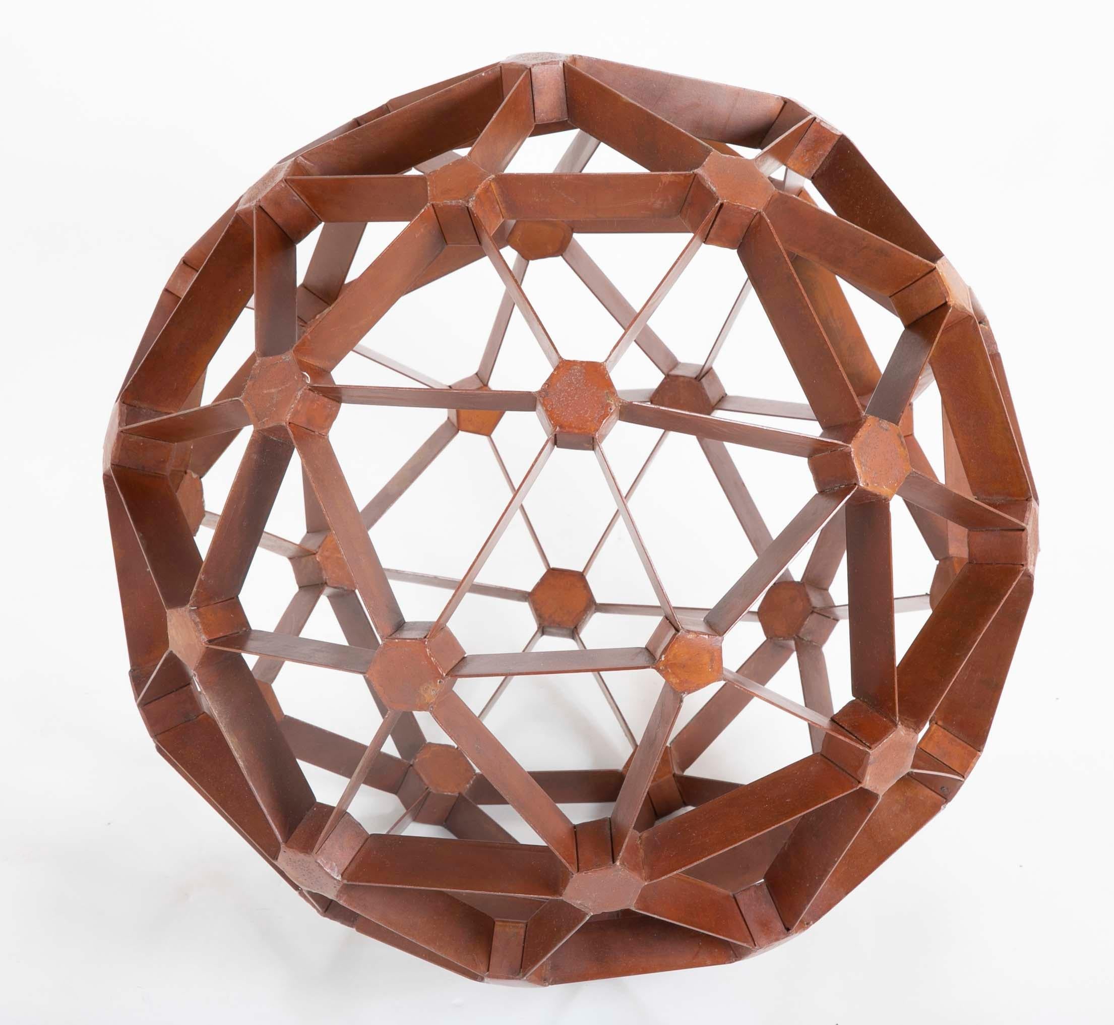 A geodesic sphere made of waxed steel in the manner of Buckmiester Fuller. A geodesic sphere or dome is a lightweight but very strong round structure made from interconnecting triangles. If the round structure is complete it's a geodesic sphere.