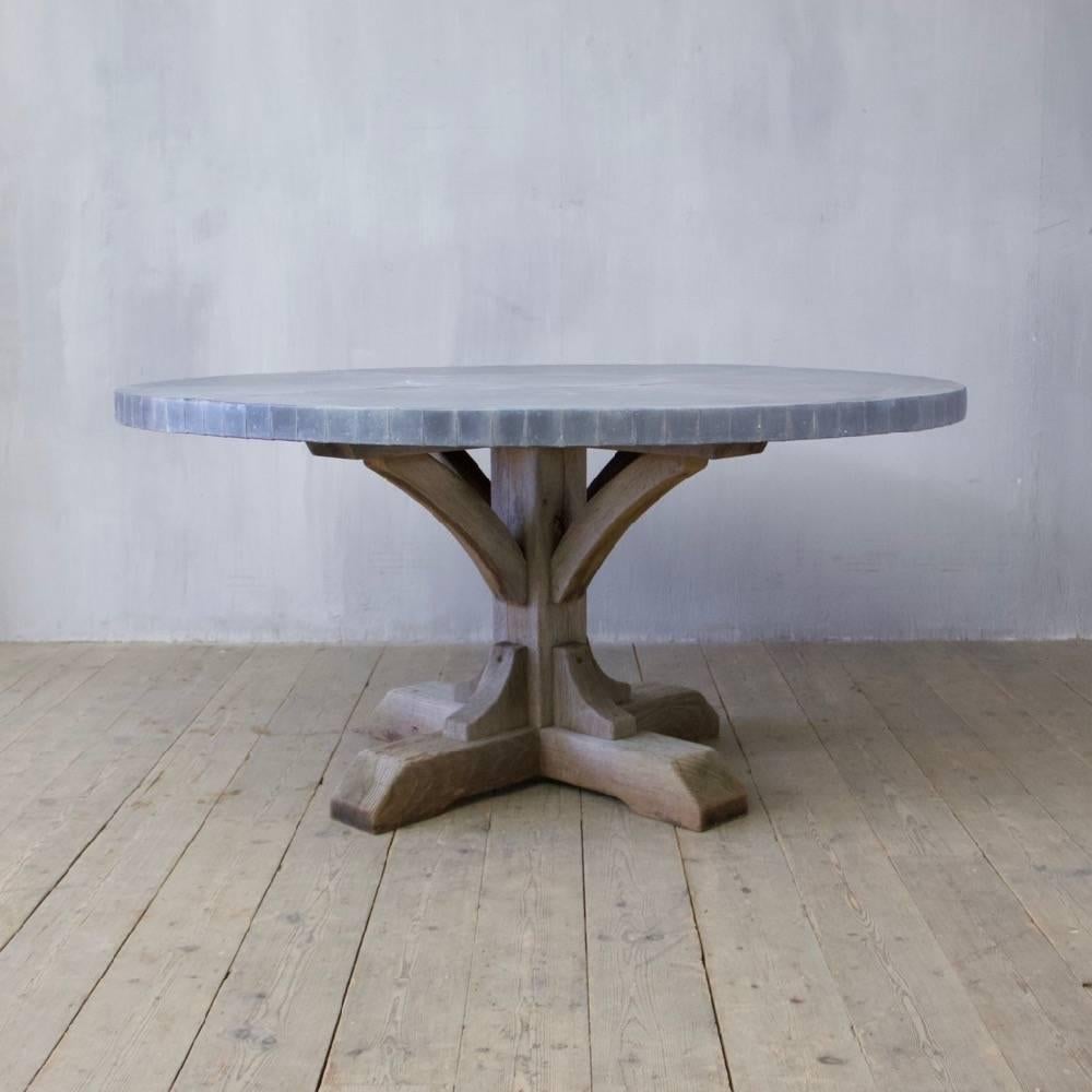 An architectural oak and zinc pedestal dining table, England.