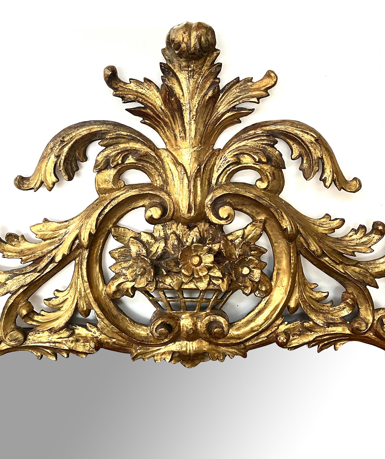 surmounted by a bold foliate crest above an openwork floral basket over a reticulated frame of cascading floral vines, lively acanthus leaves, rocaille and C-scrolls