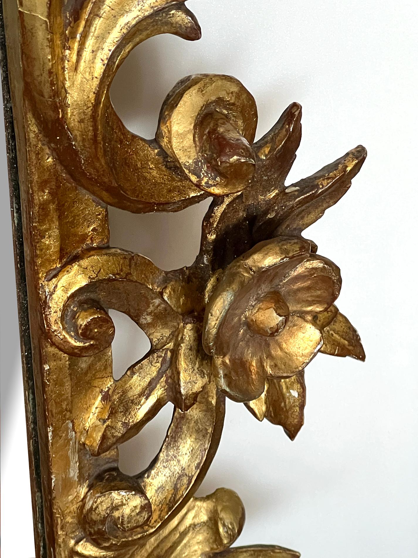 Hand-Carved A Well-Carved French Rococo Style Giltwood Wall Mirror with Exuberant Crest For Sale