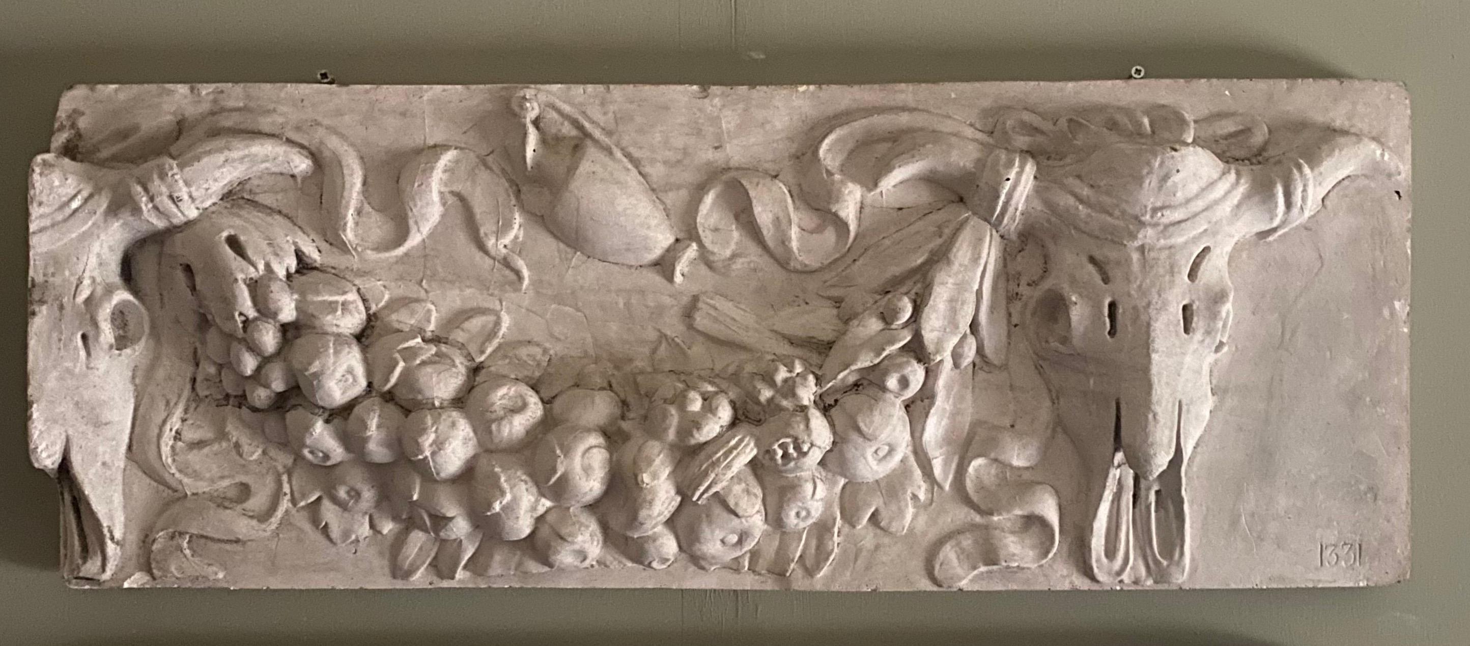 A wonderfully detailed and well cast Bucranium plaster frieze featuring Ox skulls and garlands.

To the lower right is the number 1331 which is more than likely a museum reference. The piece is in very good condition with natural ageing.